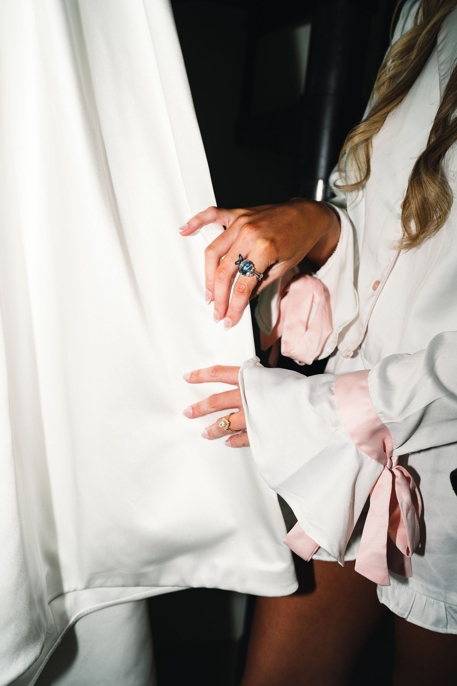 Close-up sequence of hands adjusting white formal attire.