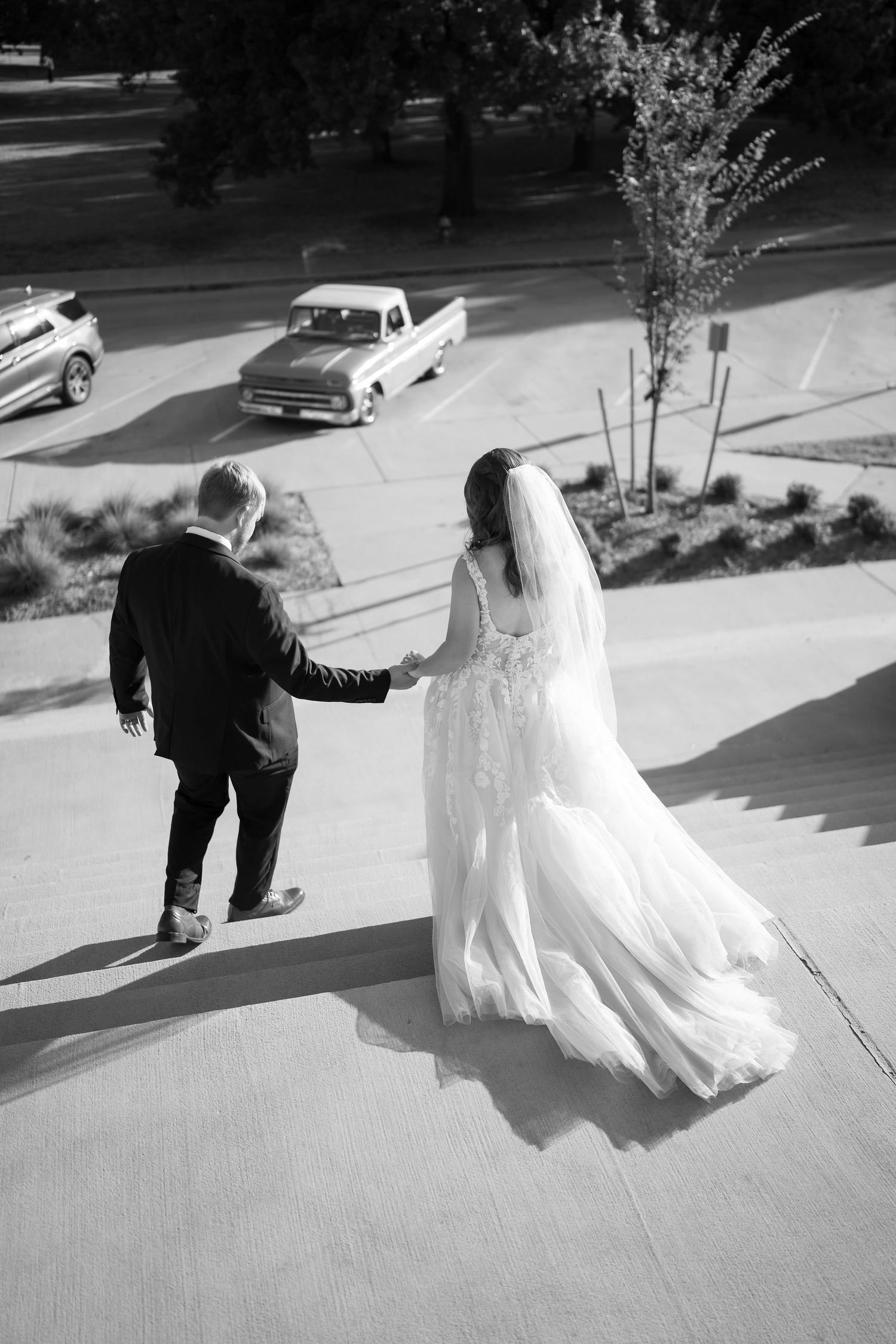 Black and white sequence showing the bride's dress flowing in motion during outdoor portraits.