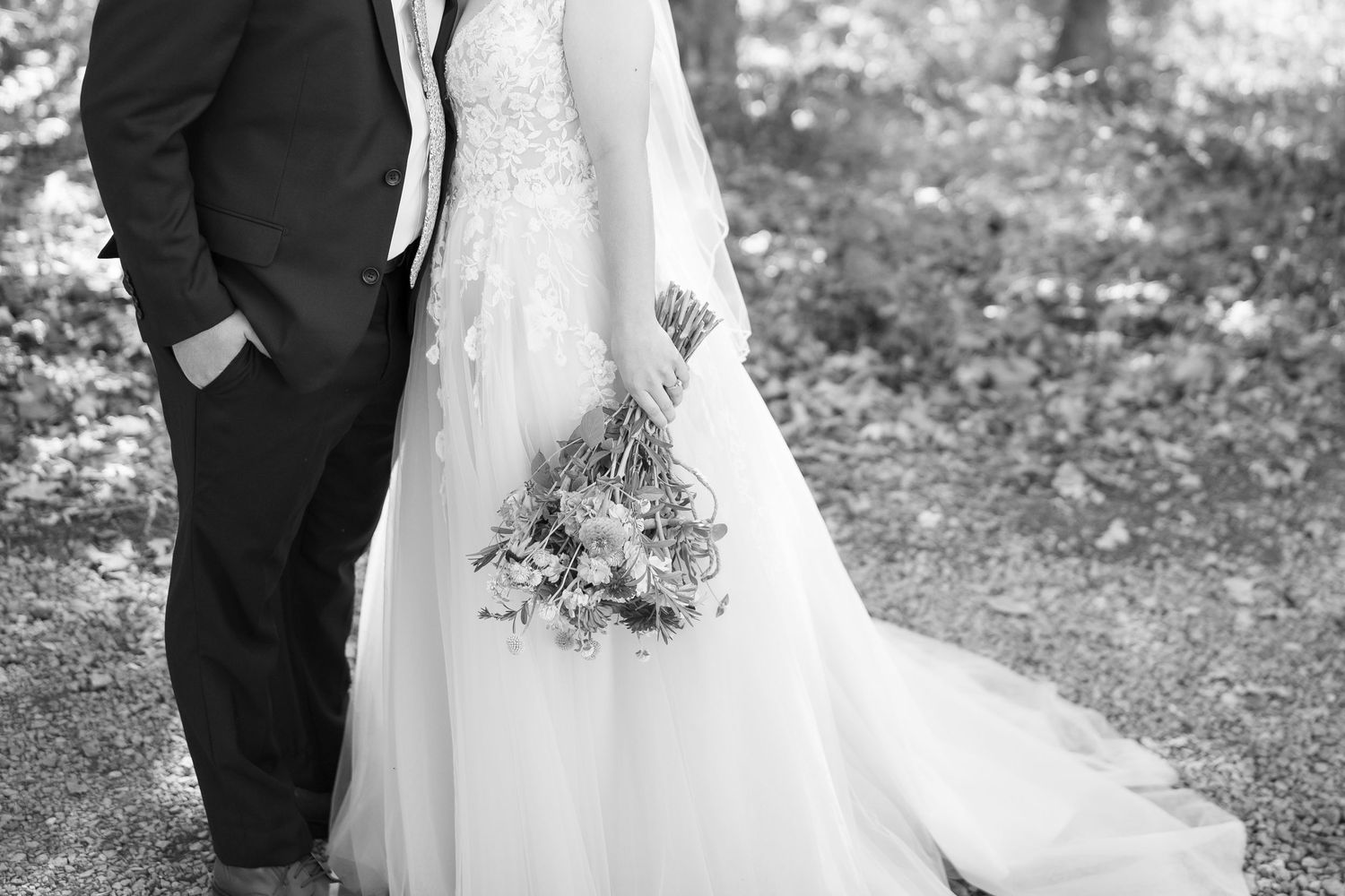 Black and white wedding portrait series showing close-up details of the bride's dress.