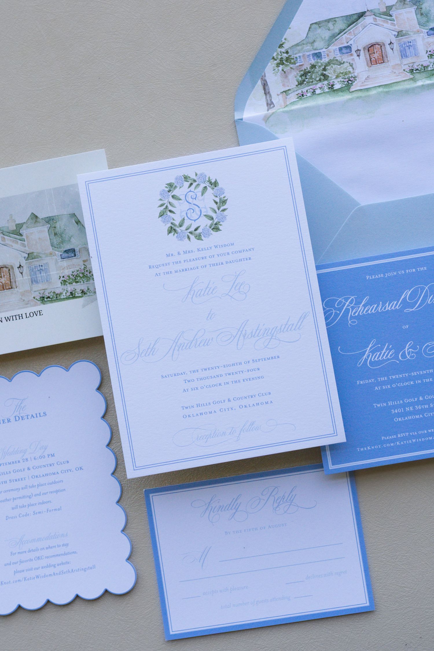 Collection of elegant blue and white wedding invitations and stationery laid out on display.