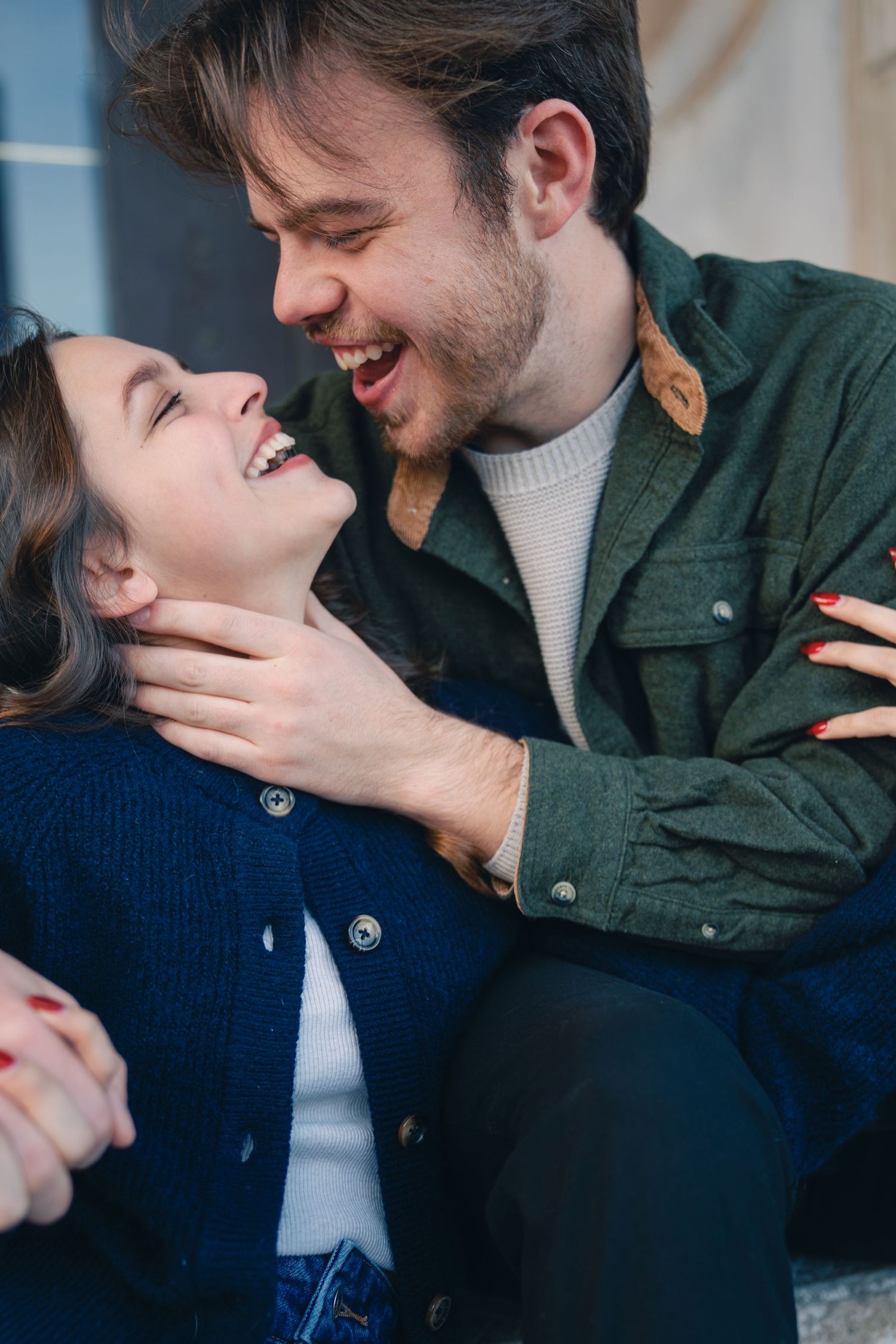 Couple sharing intimate moment on couch in casual indoor setting.