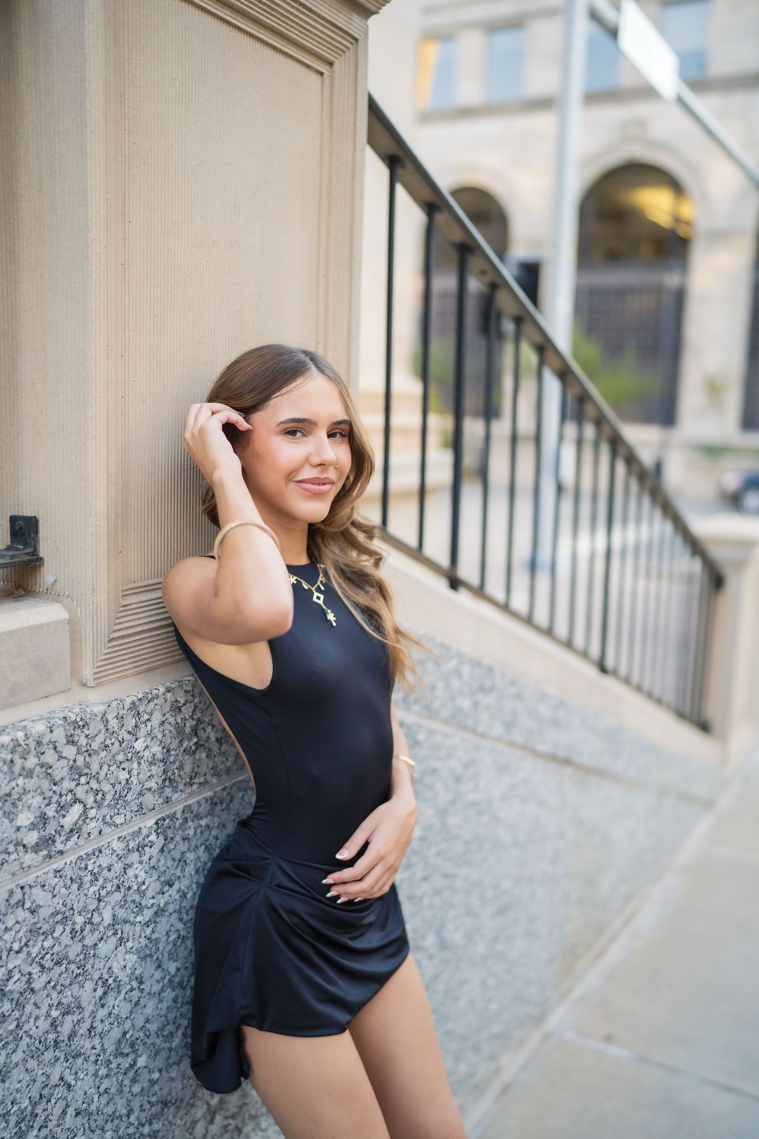 Artistic portrait series featuring poses against a textured granite wall.