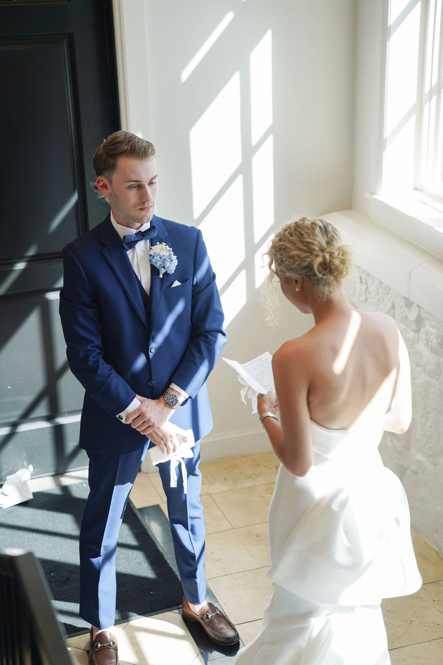 A couple shares an intimate moment while exchanging letters before their wedding ceremony.