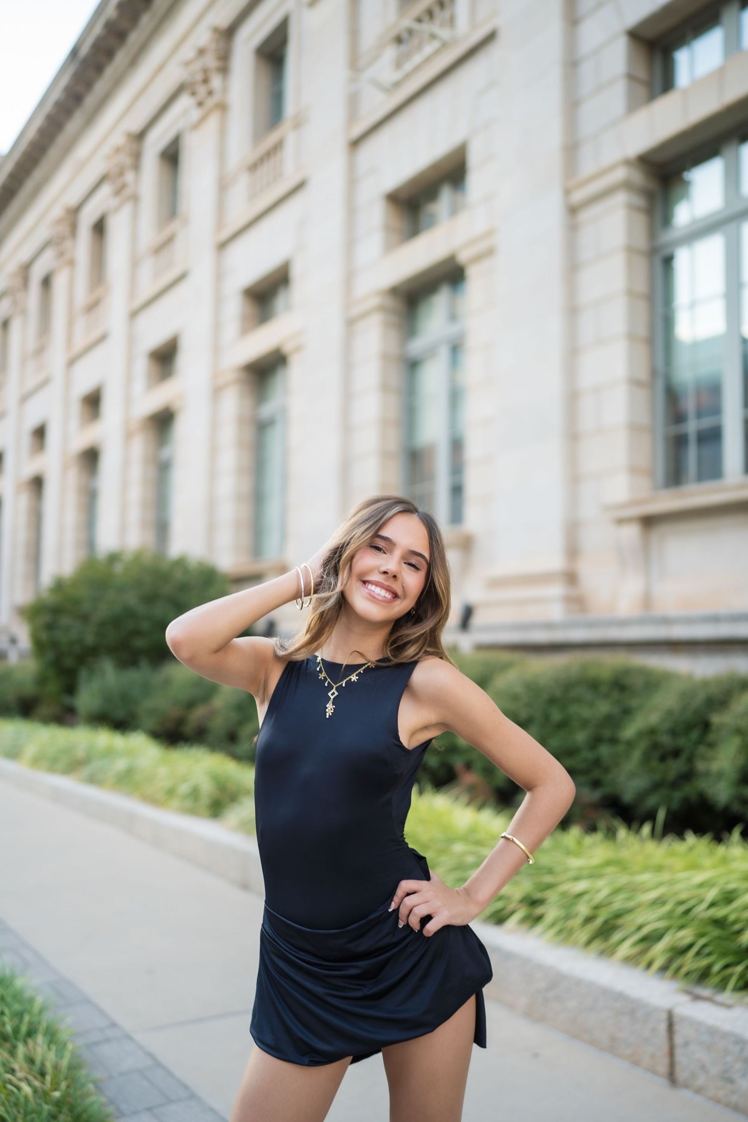 A series of dynamic portrait poses against a classical stone building facade.