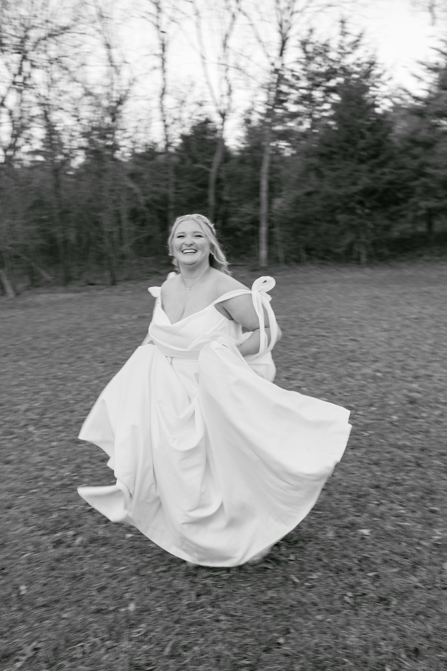 A flowing white wedding dress twirls in a series of black and white photos on a grassy field.