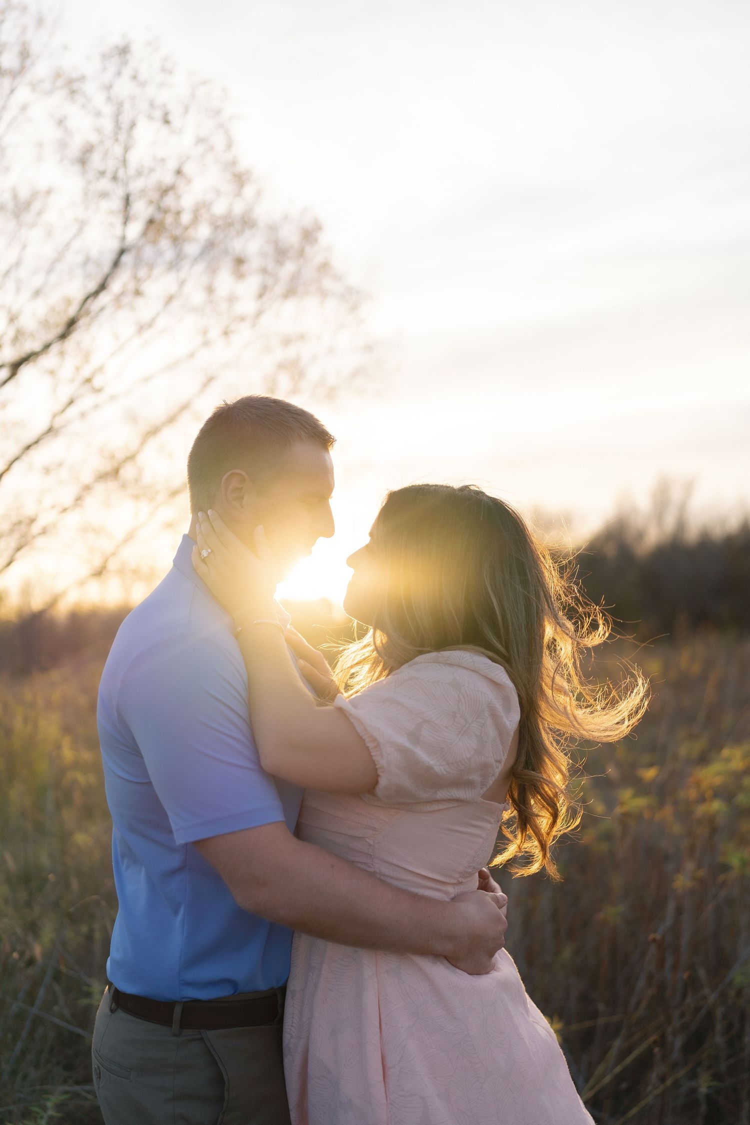 A romantic sunset silhouette captured in a golden field during golden hour.