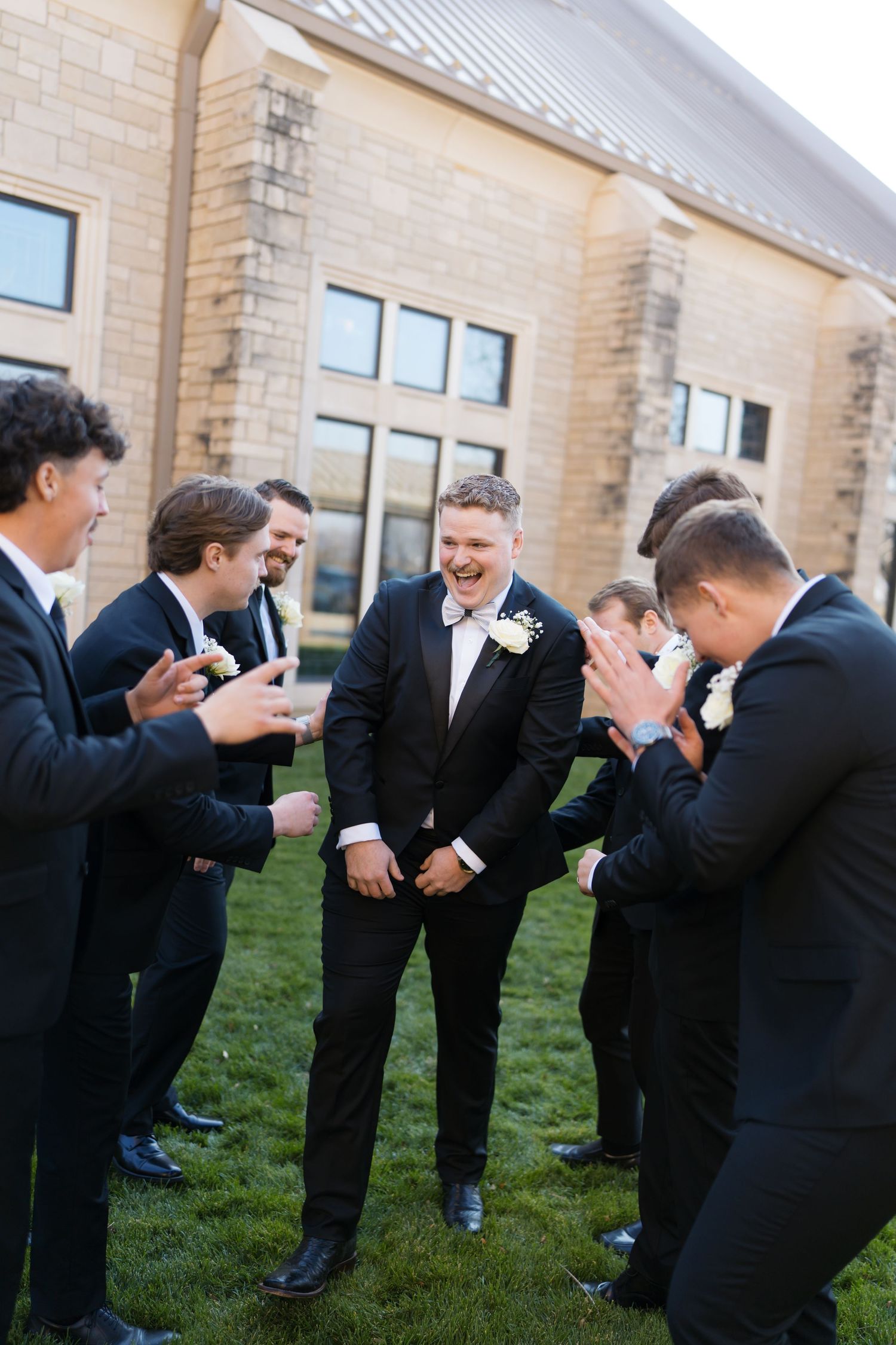 A sequence of four photos showing groomsmen in black suits laughing and bending over in hysterical laughter at an outdoor event.