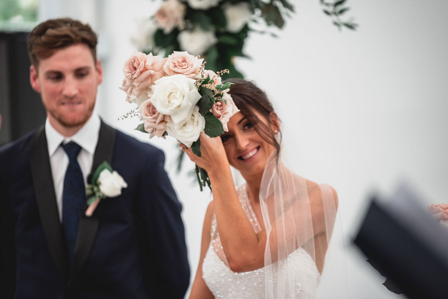 A wedding couple shares an intimate moment during their ceremony as they exchange rings and vows.