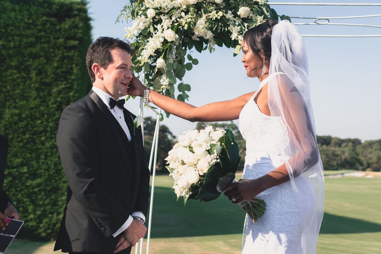 A series of romantic wedding photos showing tender moments between newlyweds in an outdoor garden setting.