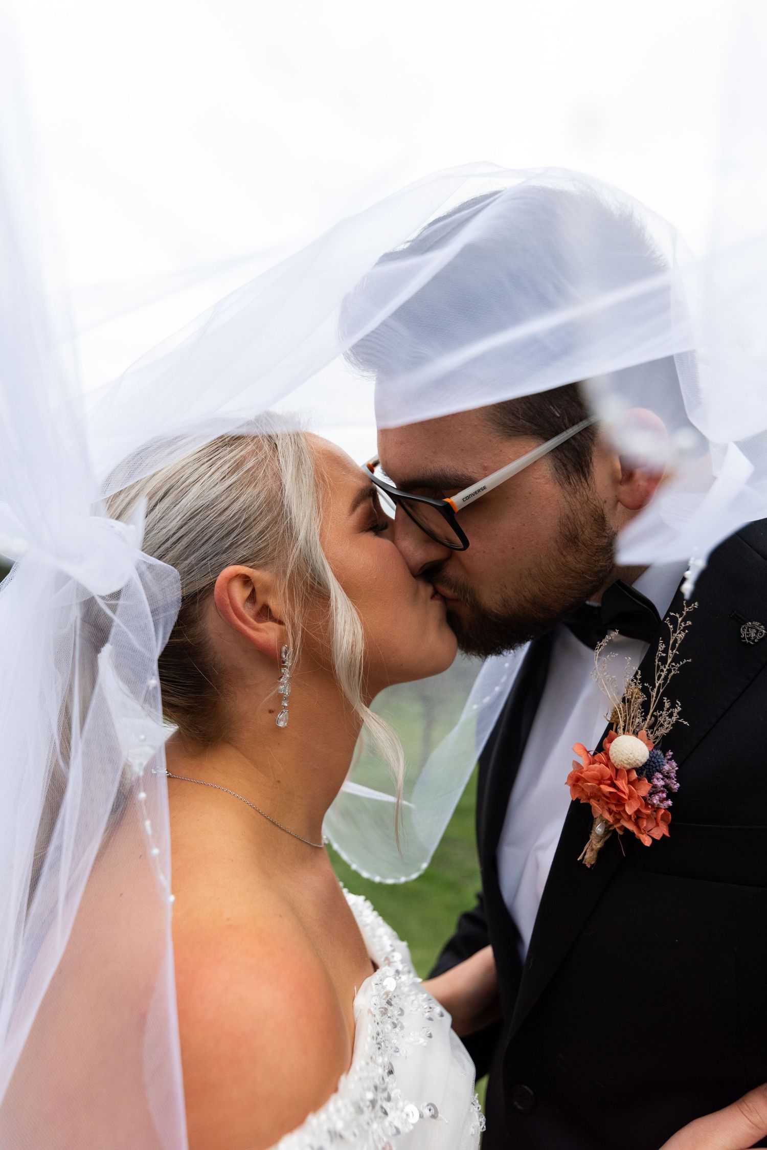 Romantic wedding veil shots of couple sharing intimate moments.