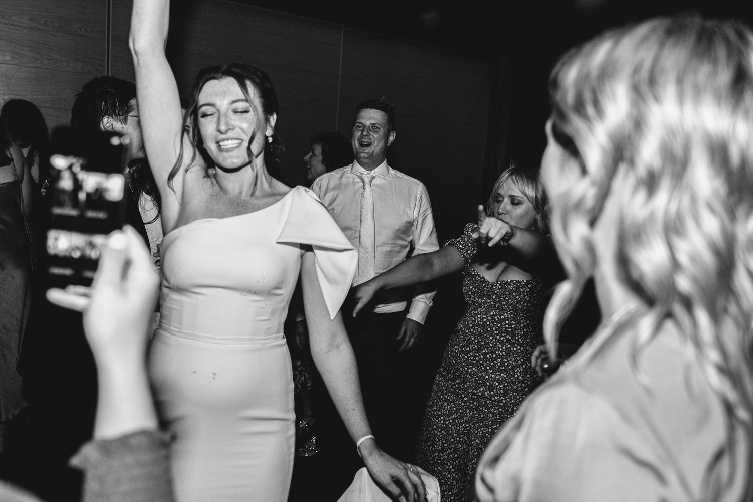 Black and white photos show people dancing and celebrating at what appears to be a wedding reception or party.