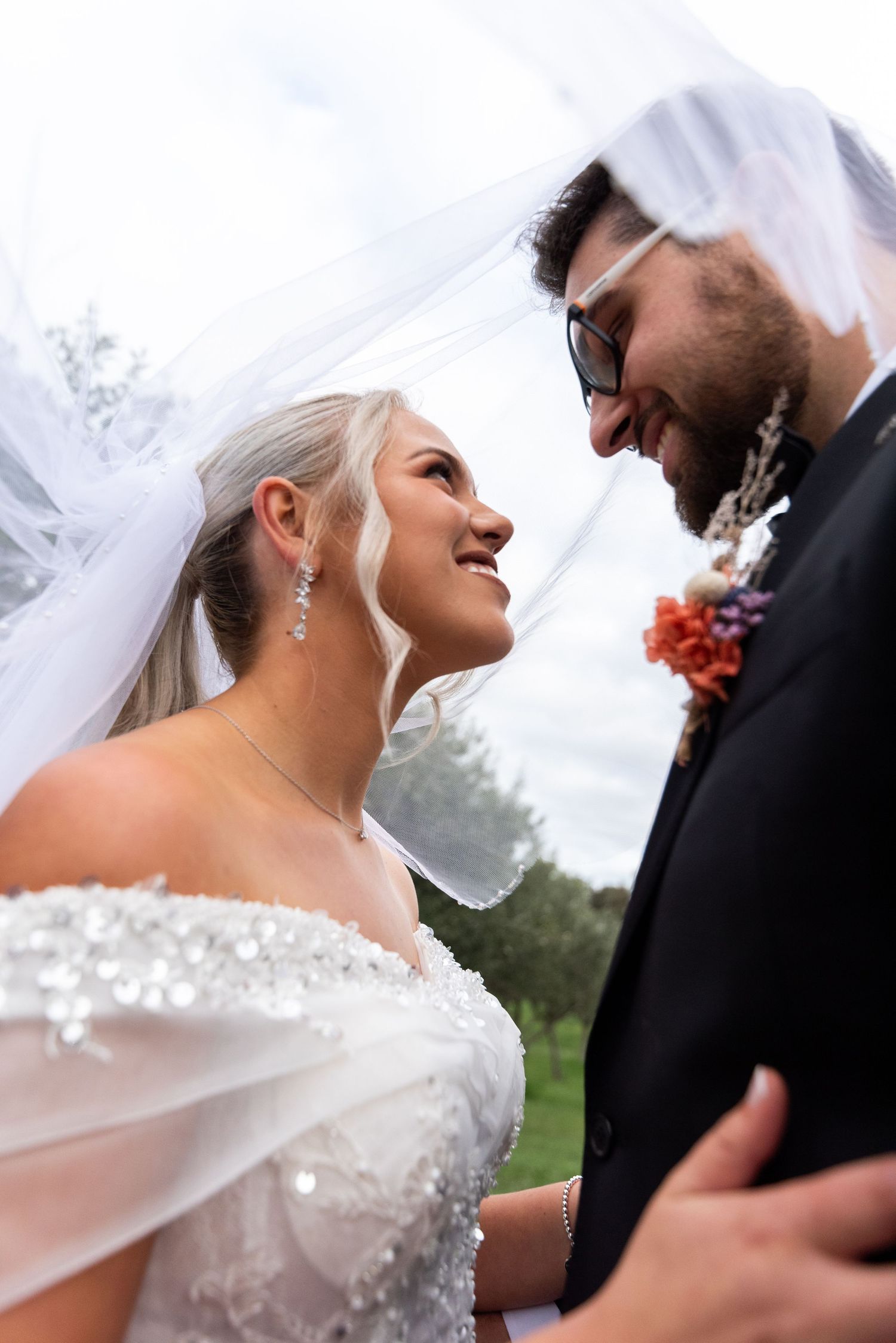 A romantic series of wedding photos showing close-up moments between a bride in white and groom in black.