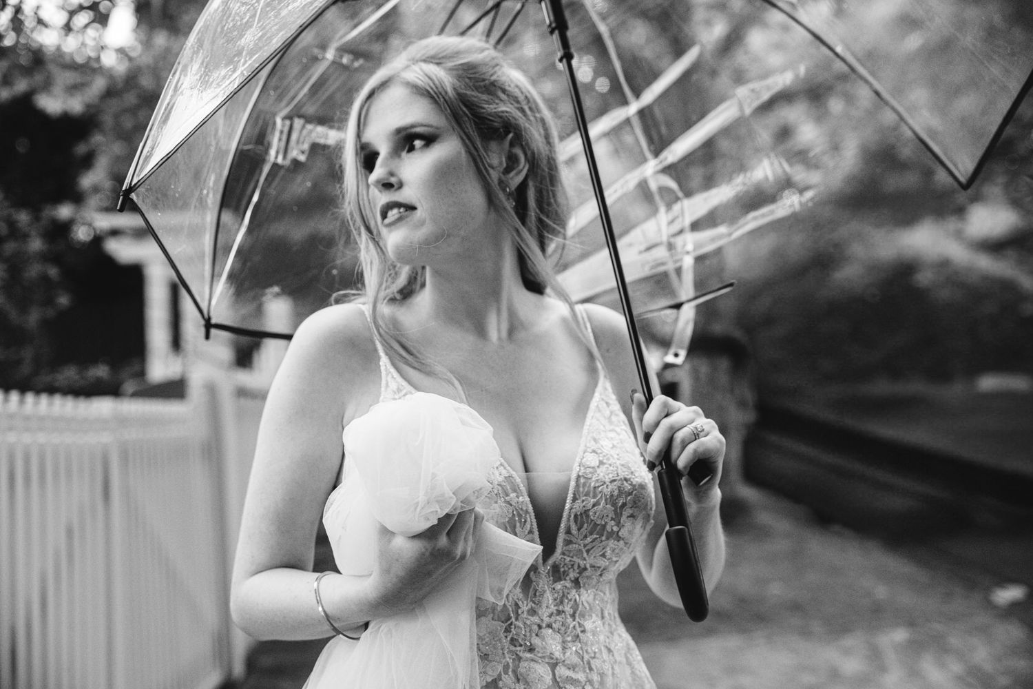 A wedding celebration with umbrellas and laughter on a rainy day.