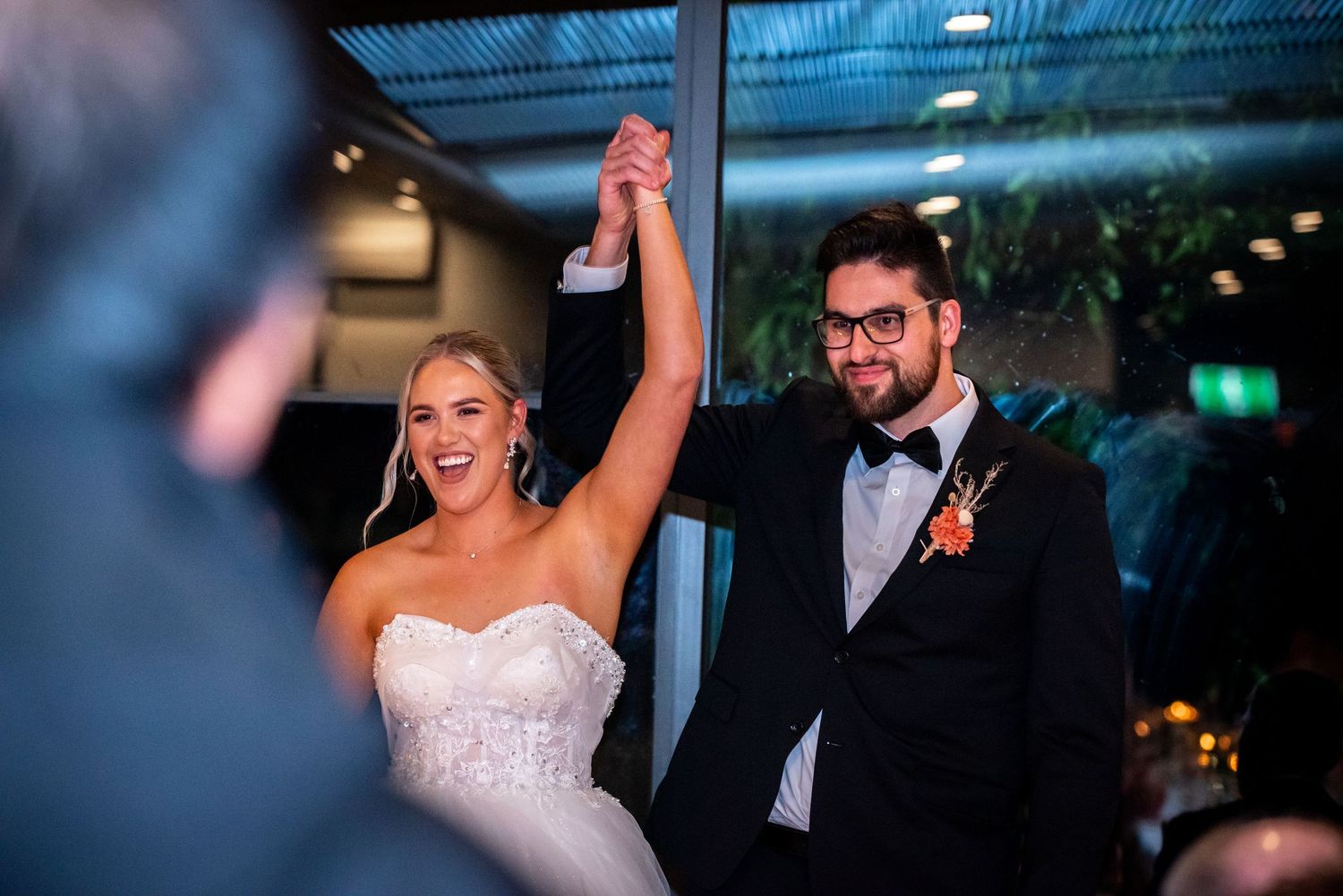 Wedding reception celebration with dramatic blue lighting and festive atmosphere.
