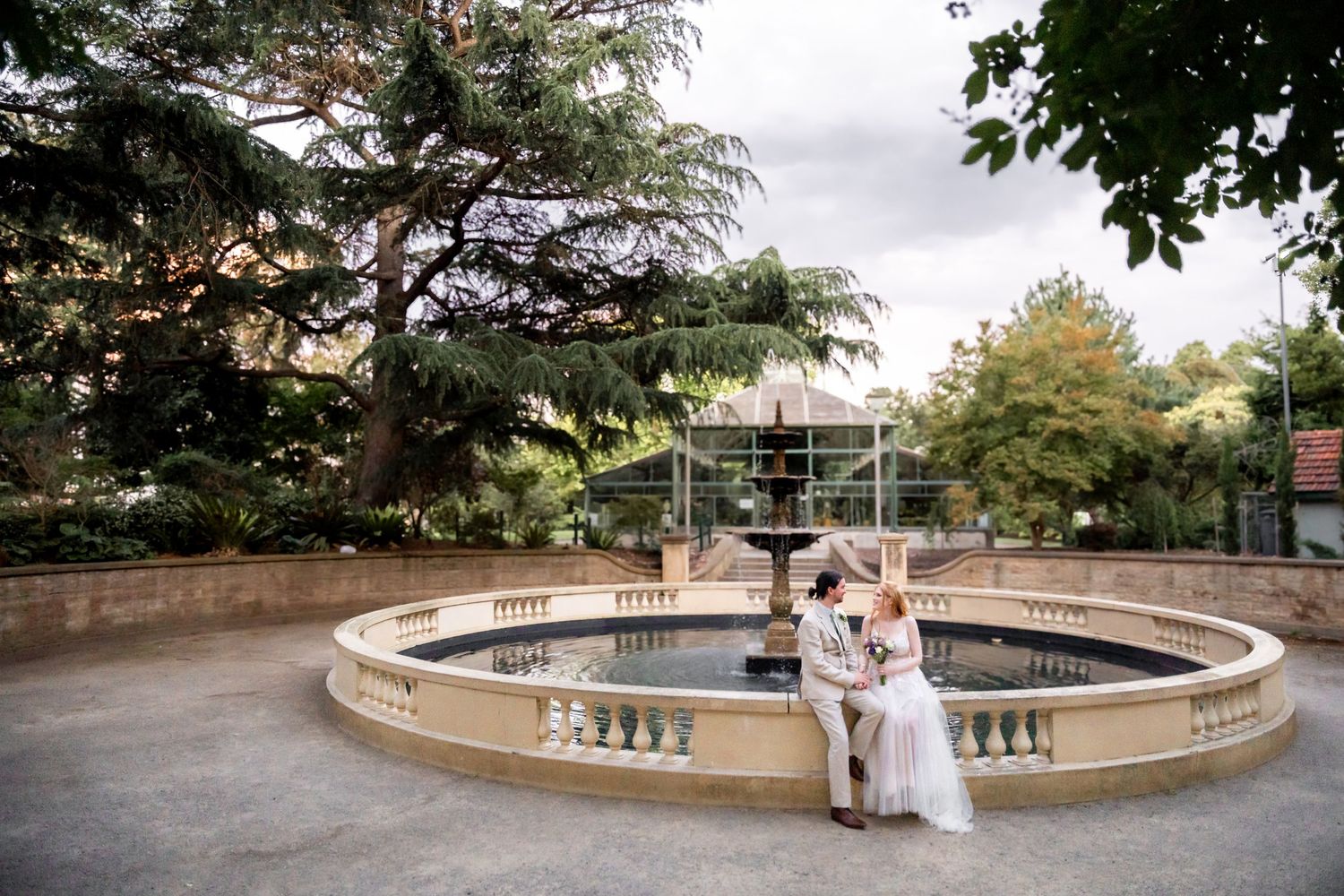 Panoramic view of a curved stone balustrade in a garden wedding venue.