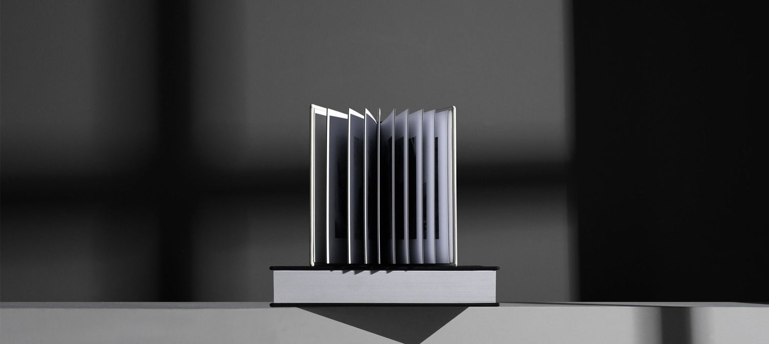 Sleek modern heatsink with parallel aluminum fins mounted on a metallic base against dark background.