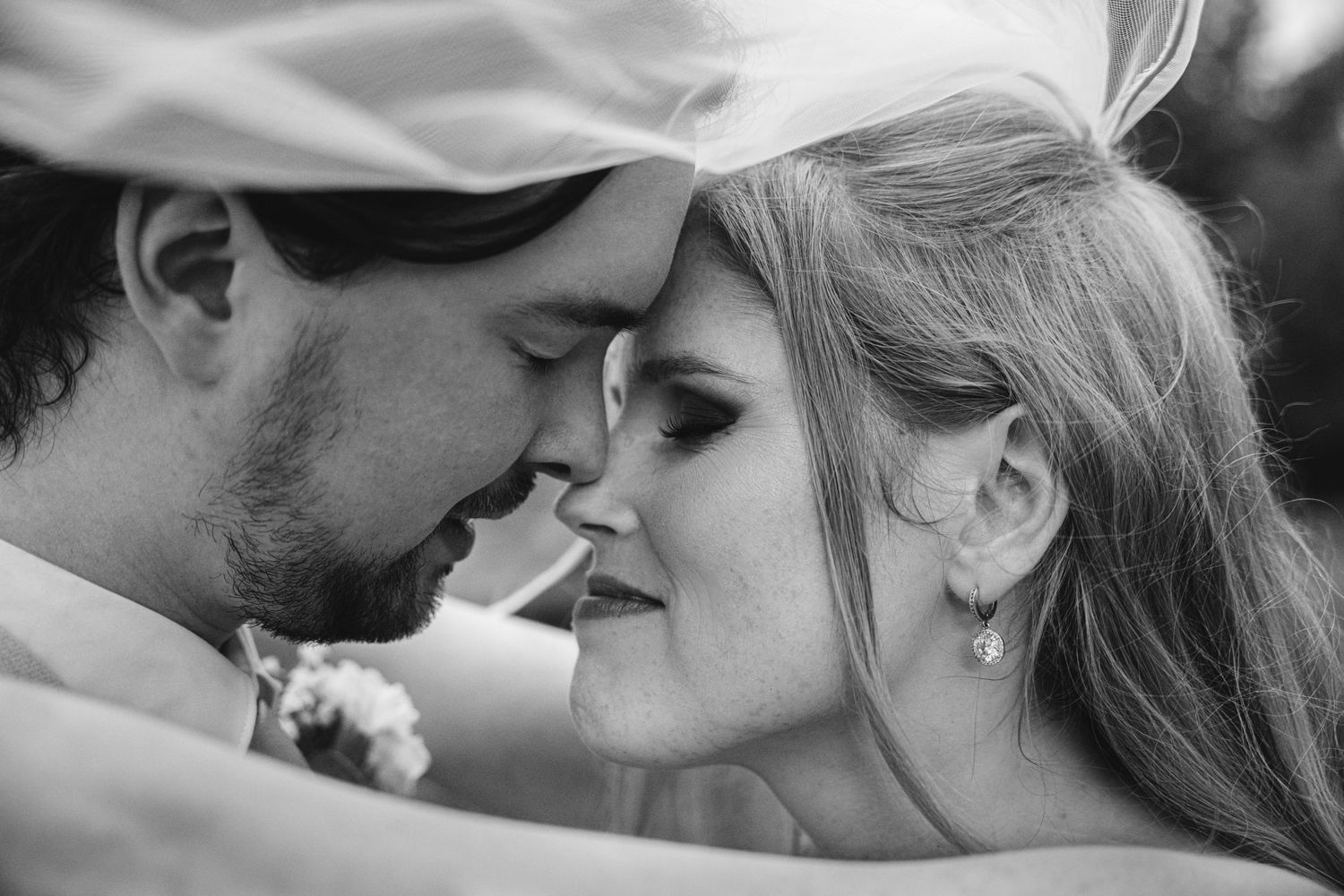 A tender black and white close-up moment between newlyweds.