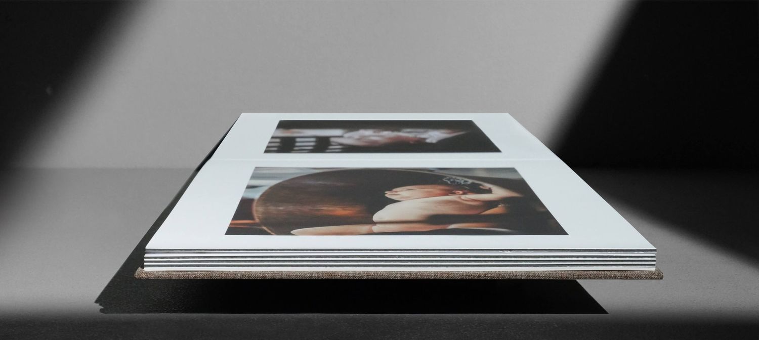 A series of five black and white photographs arranged horizontally showing different framed artworks.