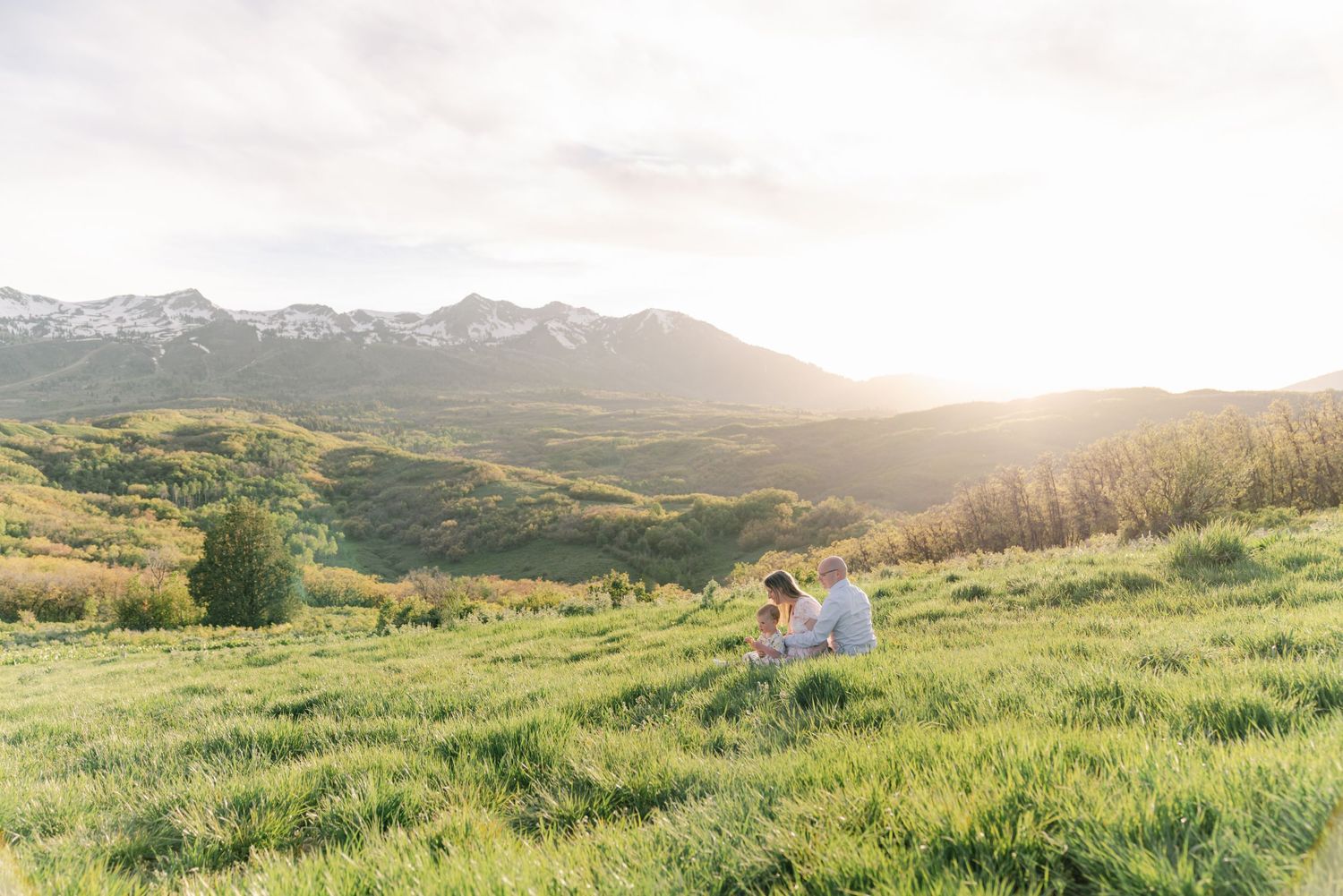 Family of three enjoying a warm, natural family session at Trapper’s Loop, Northern Utah, captured with timeless, true-to-color style.