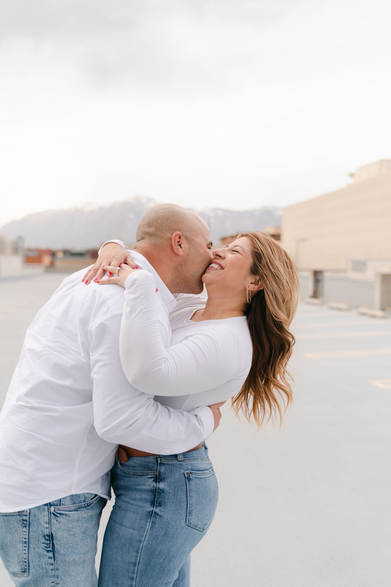 Couple sharing rooftop moments in Ogden, Utah, captured with a city-themed vibe and timeless, true-to-color photography.
