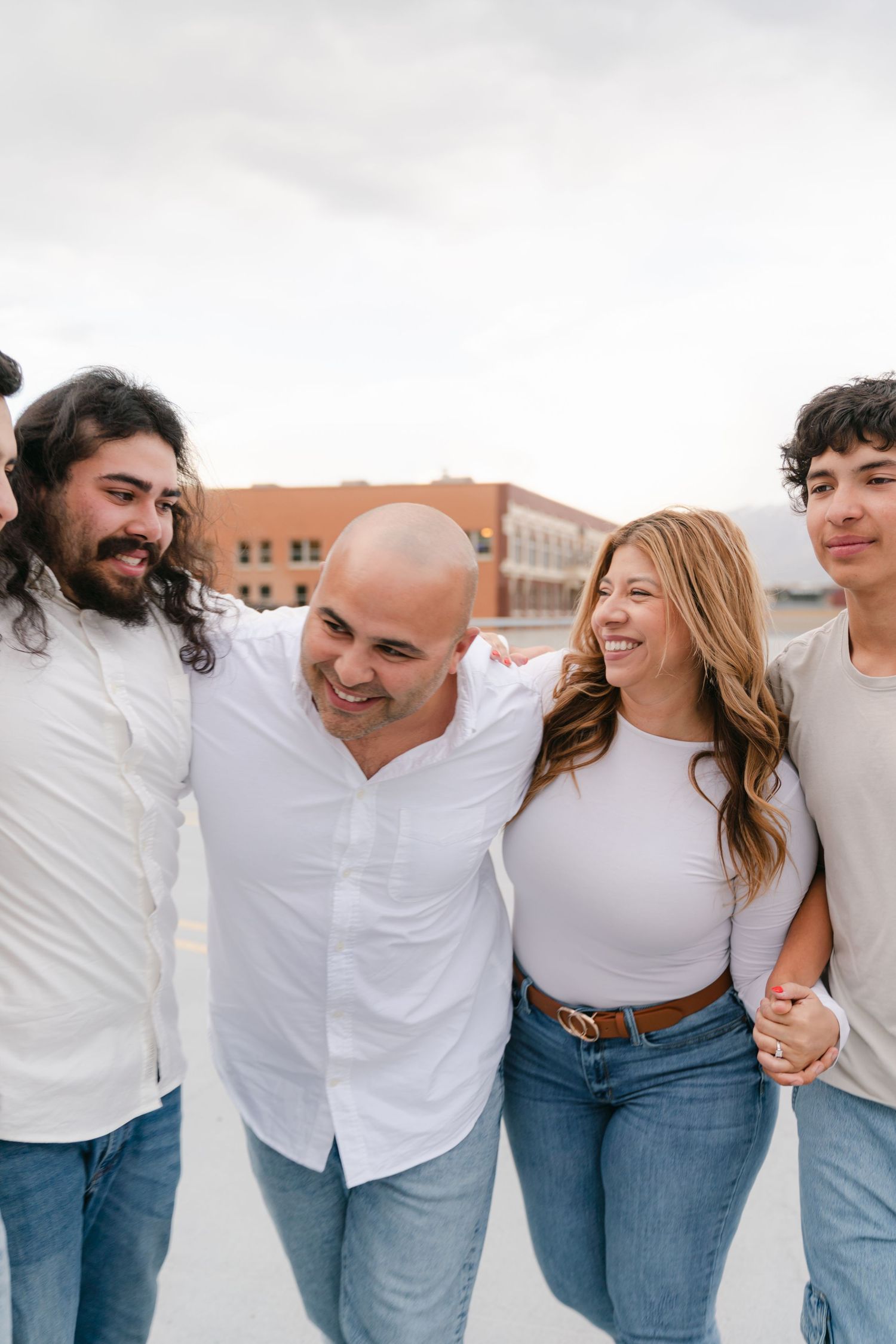 Family of 5 sharing rooftop moments in Ogden, Utah, captured with a city-themed vibe and timeless, true-to-color photography.
