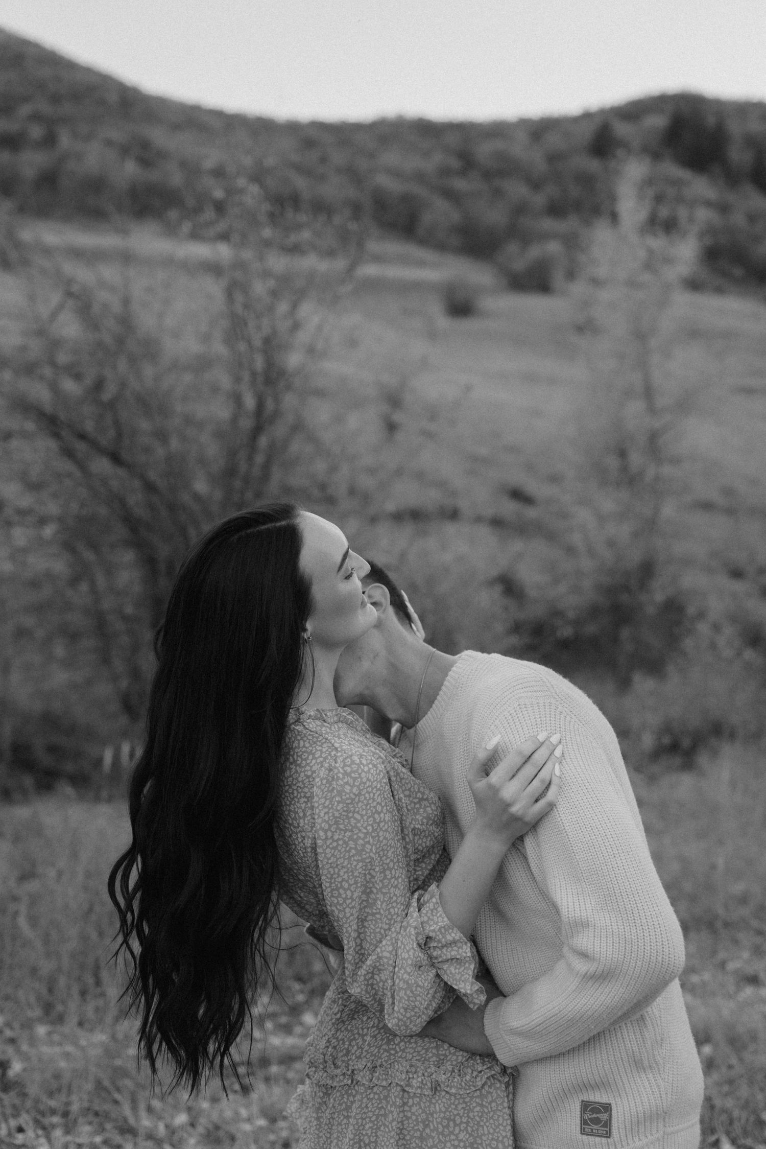 Couple candidly posing on the North Alt Trail in Utah, captured with natural light and timeless, true-to-color photography.