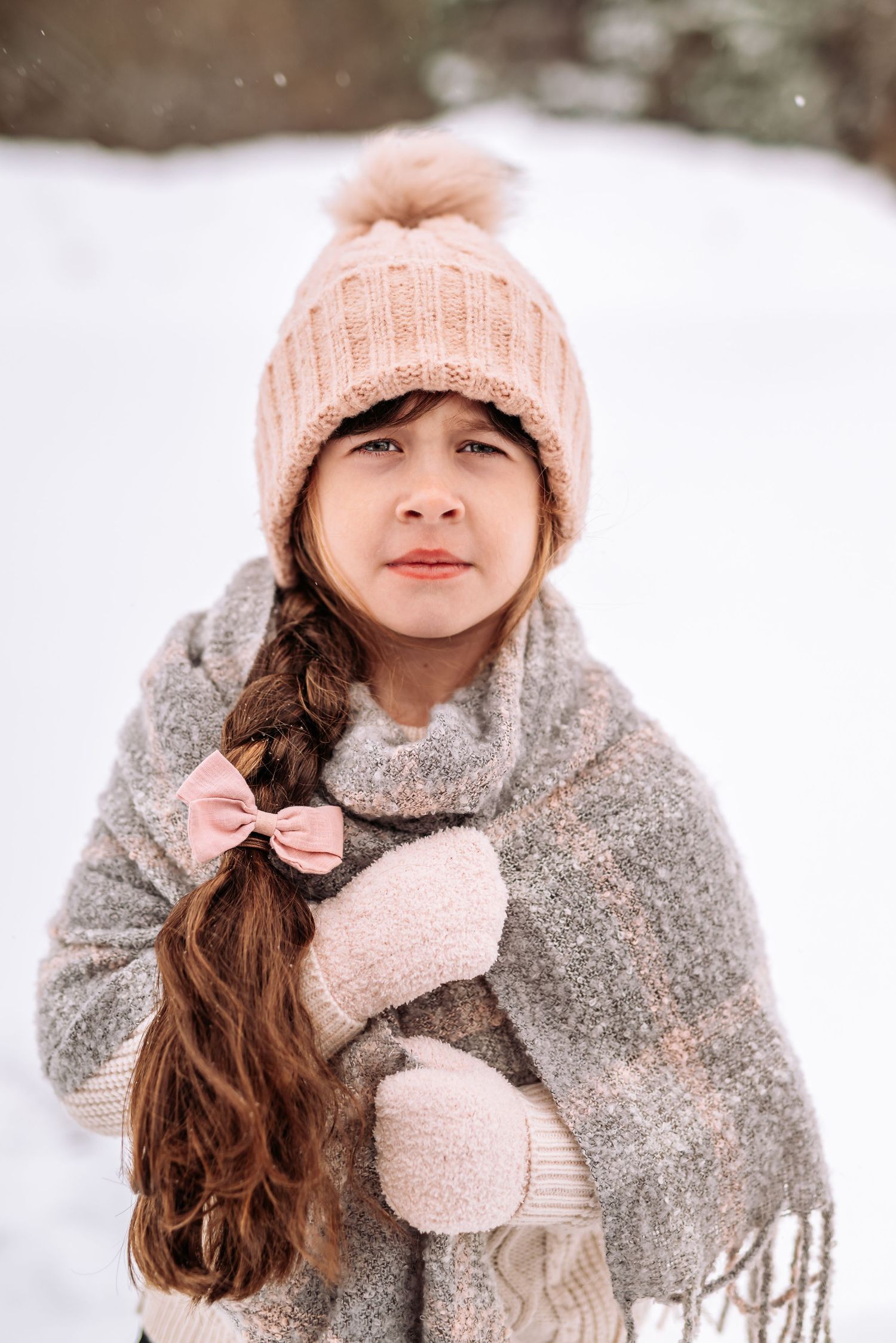 Winter portrait series showing person in pink knit hat and gray scarf against snowy background.