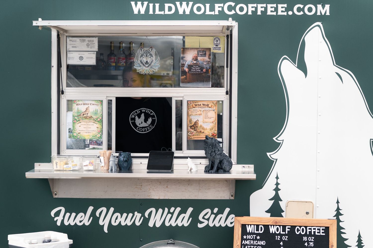 Wild Wolf Coffee food truck with green exterior, service window, and tagline Fuel Your Wild Side.