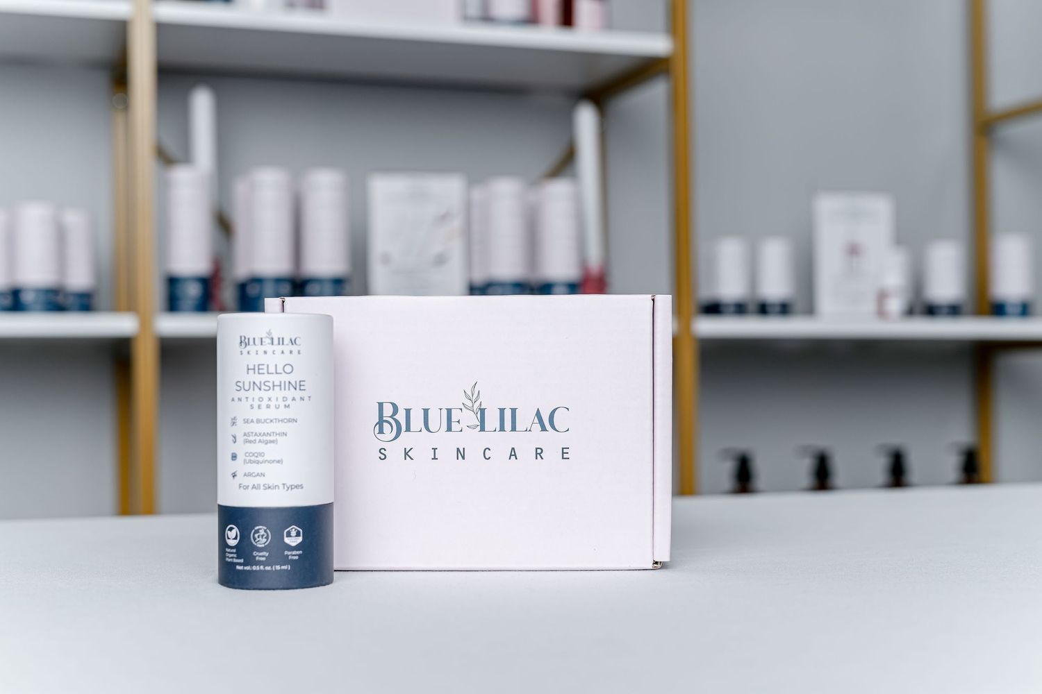 Blue Lilac Skincare white gift box with a skincare product tube displayed on a shelf with beauty products.
