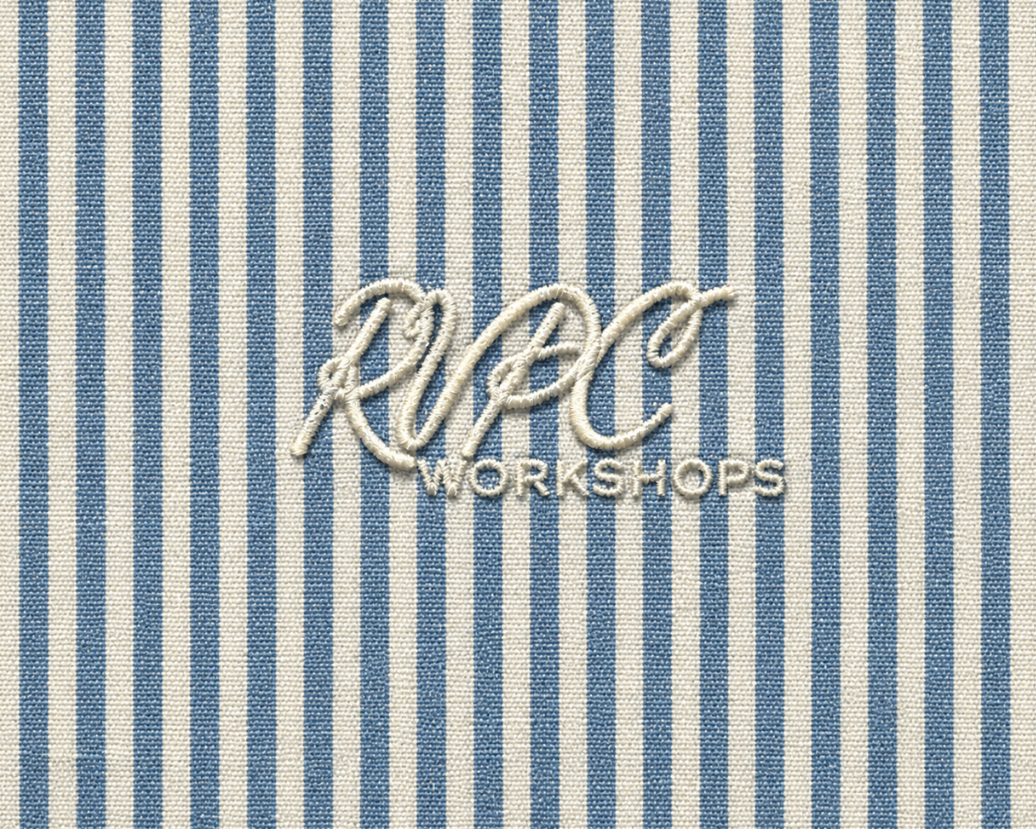 RVPC Workshops embroidered logo on blue and white striped fabric textile background.