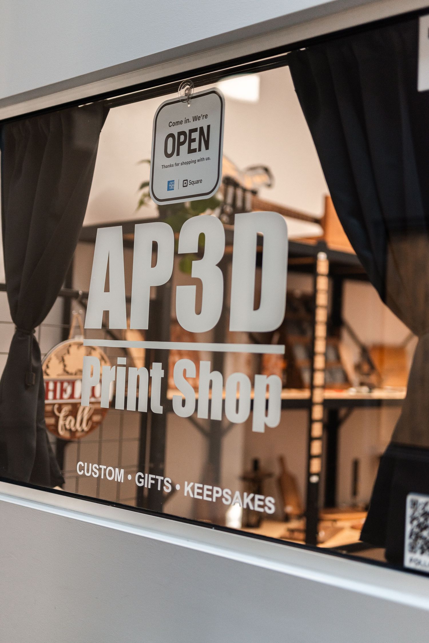 AP3D Print Shop storefront window displaying custom gifts and keepsakes sign with Open notice.