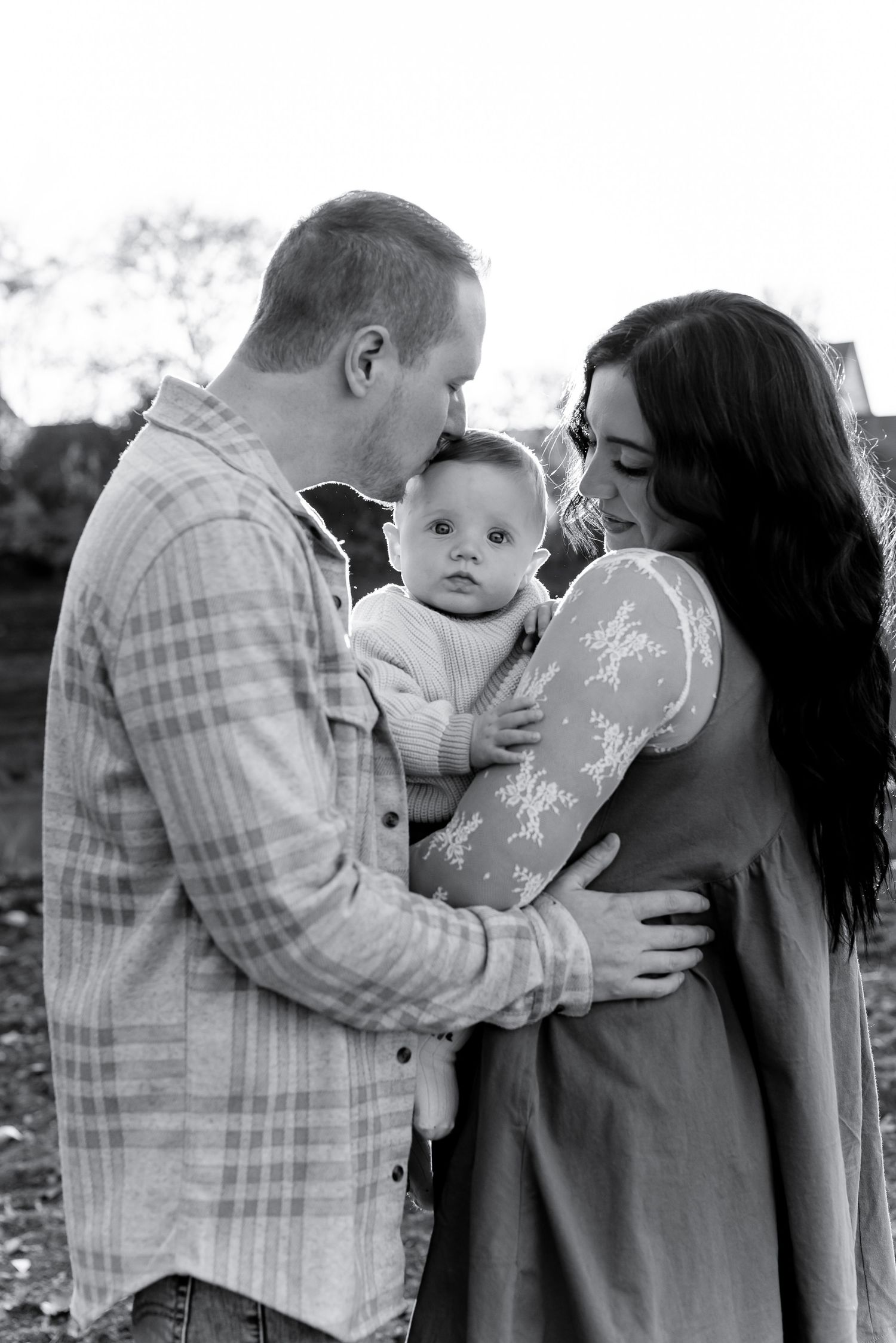 A series of intimate family moments captured in black and white photographs showing tender interactions.