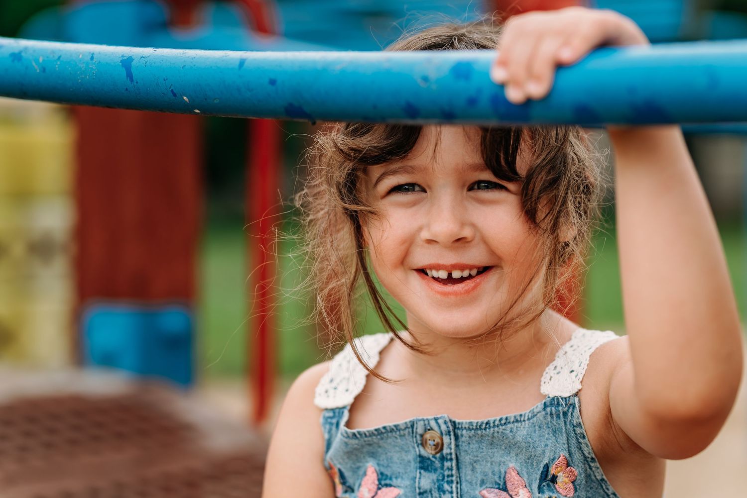 Child enjoying outdoor playtime on playground equipment, captured in multiple candid moments against a vibrant background.