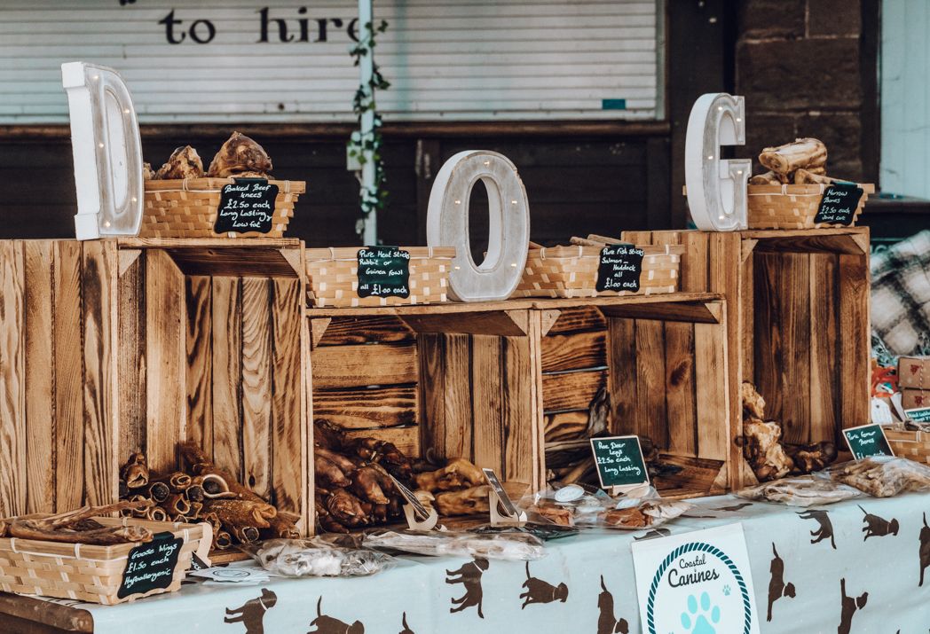 Rustic wooden crate display spelling 'DOG' with small chalkboard signs and baskets.