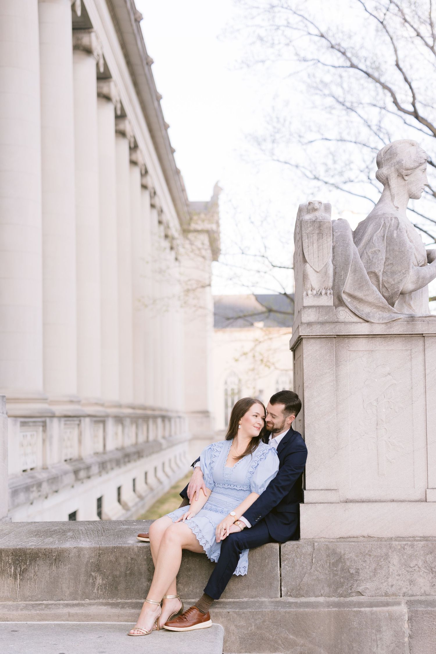Romantic engagement session at marble colonnade shown in series of intimate poses during sunset.