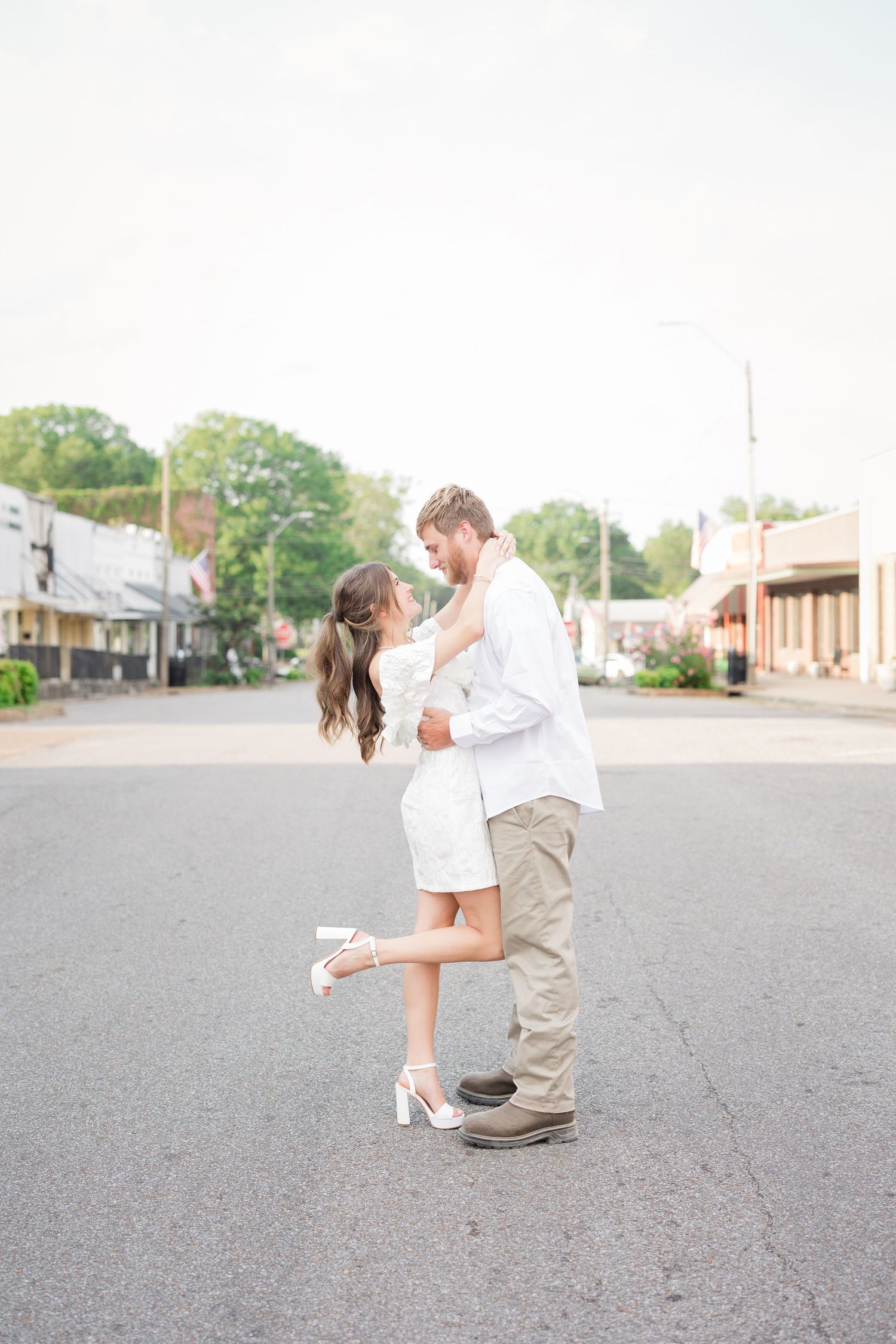 A romantic outdoor engagement photoshoot sequence shows a couple dancing together on a quiet street.