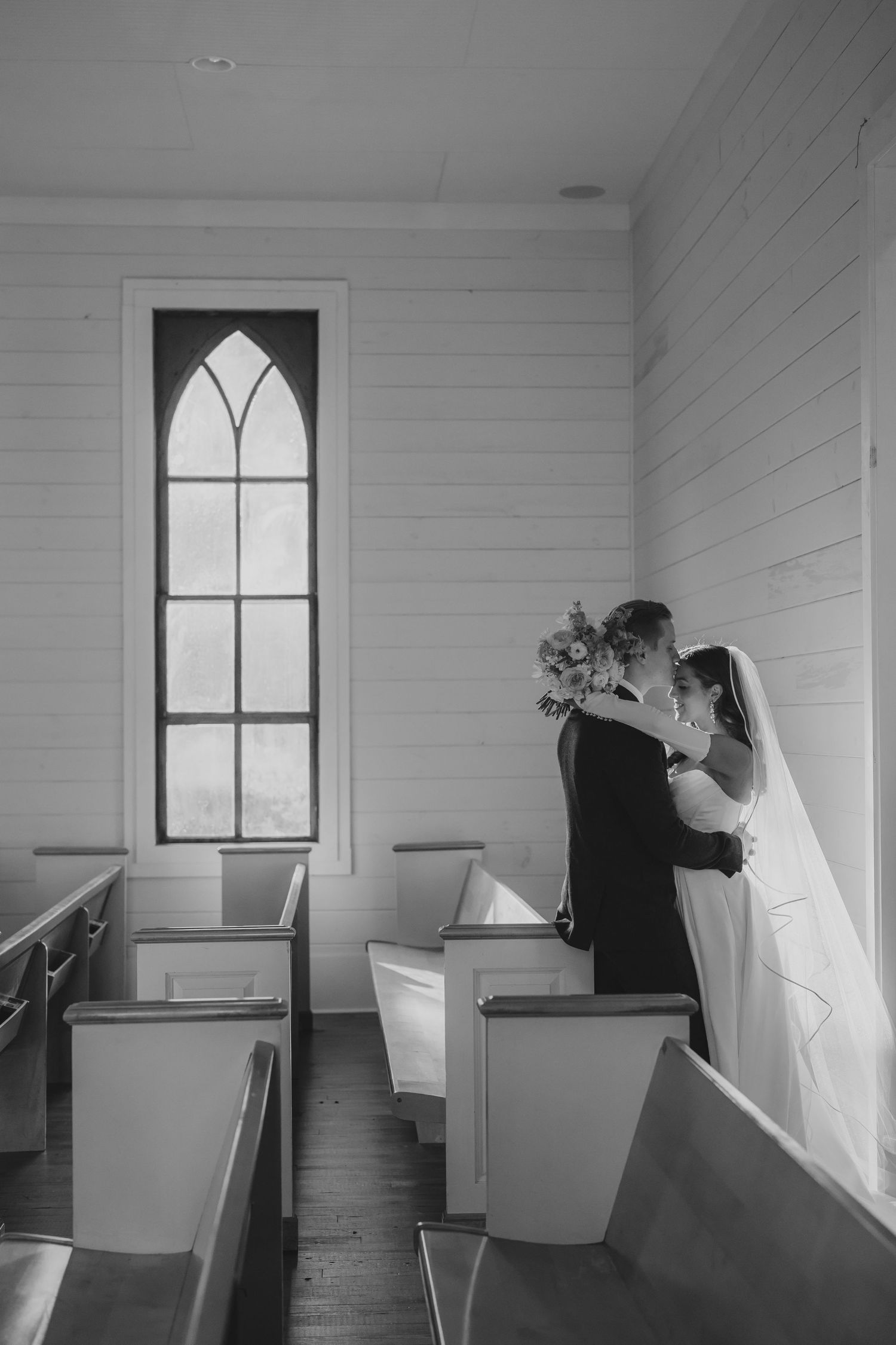 Black and white photo series showing interior of chapel with arched windows and wooden pews.