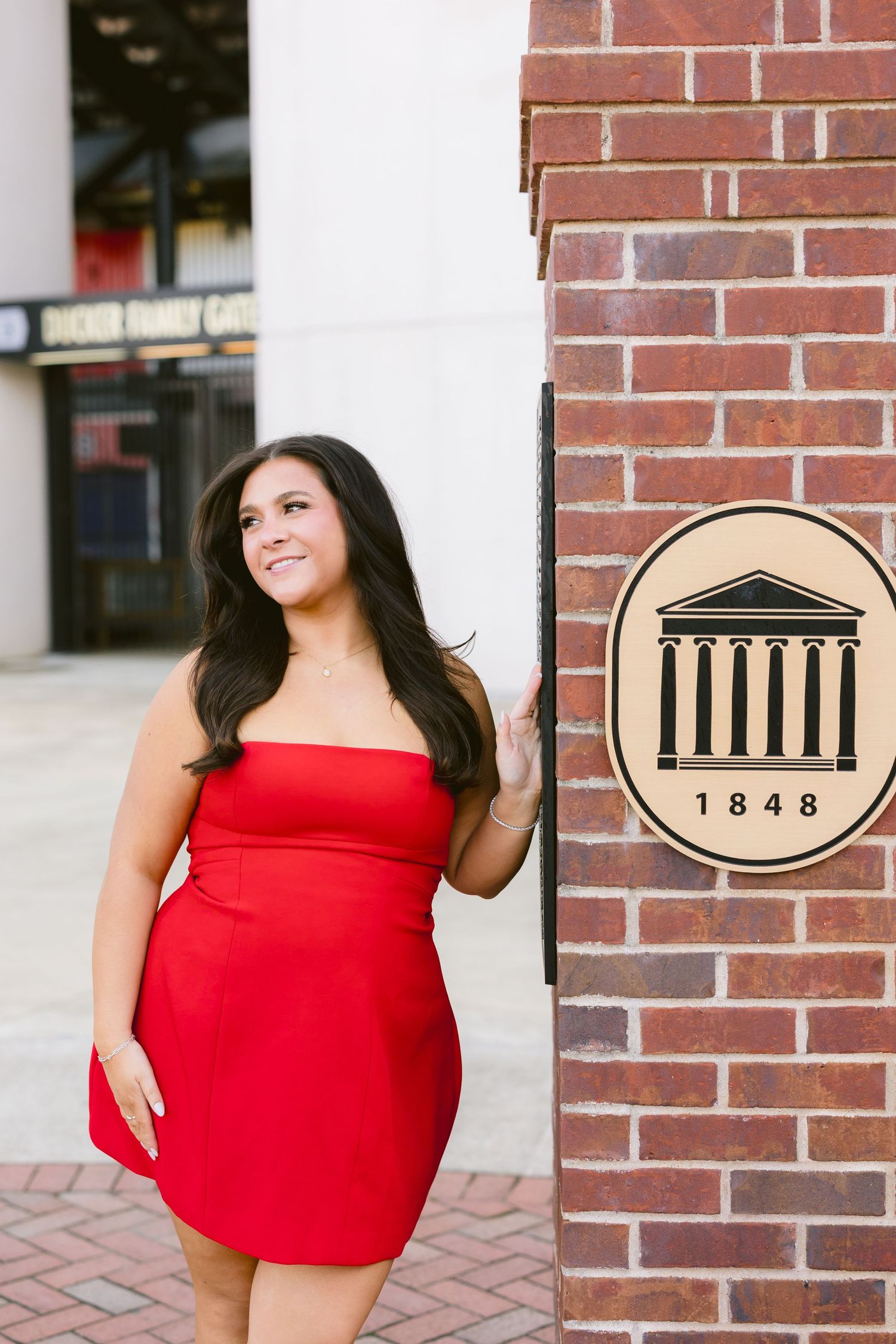 A woman in a bright red sleeveless top poses against a brick wall background in multiple cropped photos.