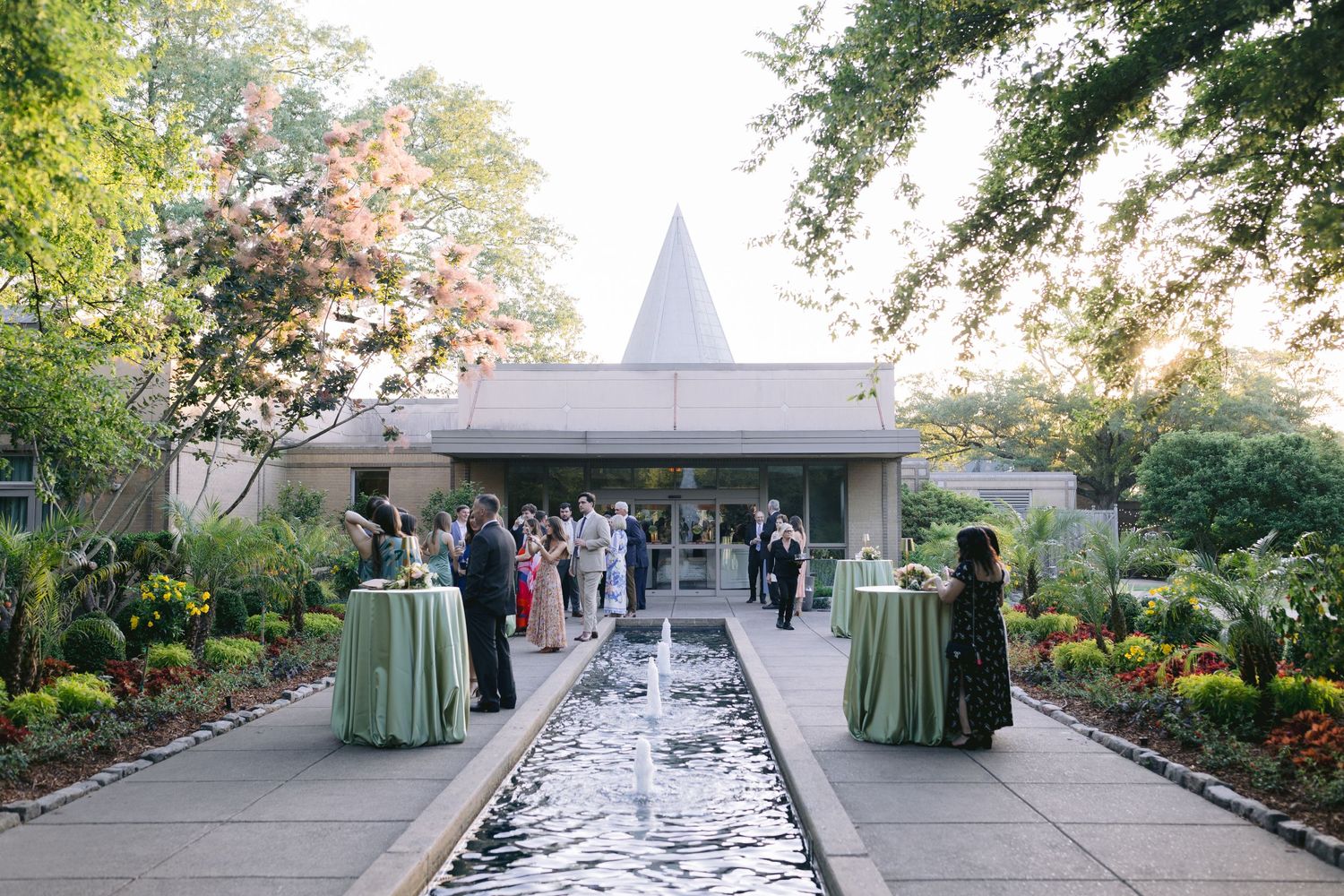 Elegant garden wedding venue featuring a long reflecting pool and landscaped pathways.