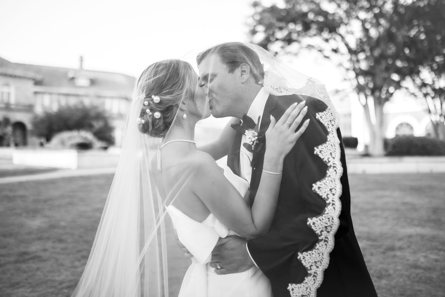 Elegant wedding couple shares intimate moments in a series of outdoor portraits.