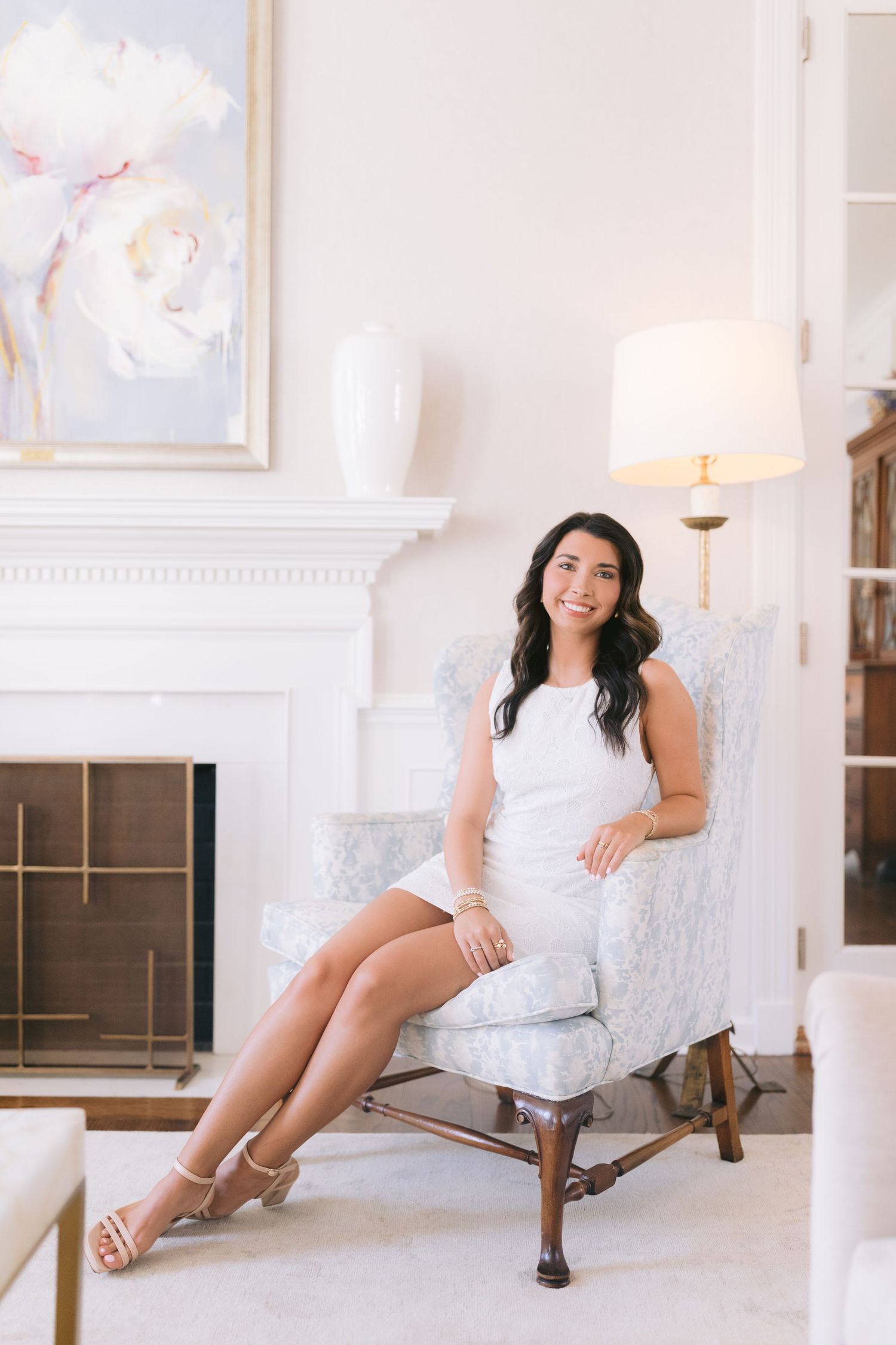 A series of elegant boudoir photos featuring a white chaise lounge and soft natural lighting in a bright studio setting.