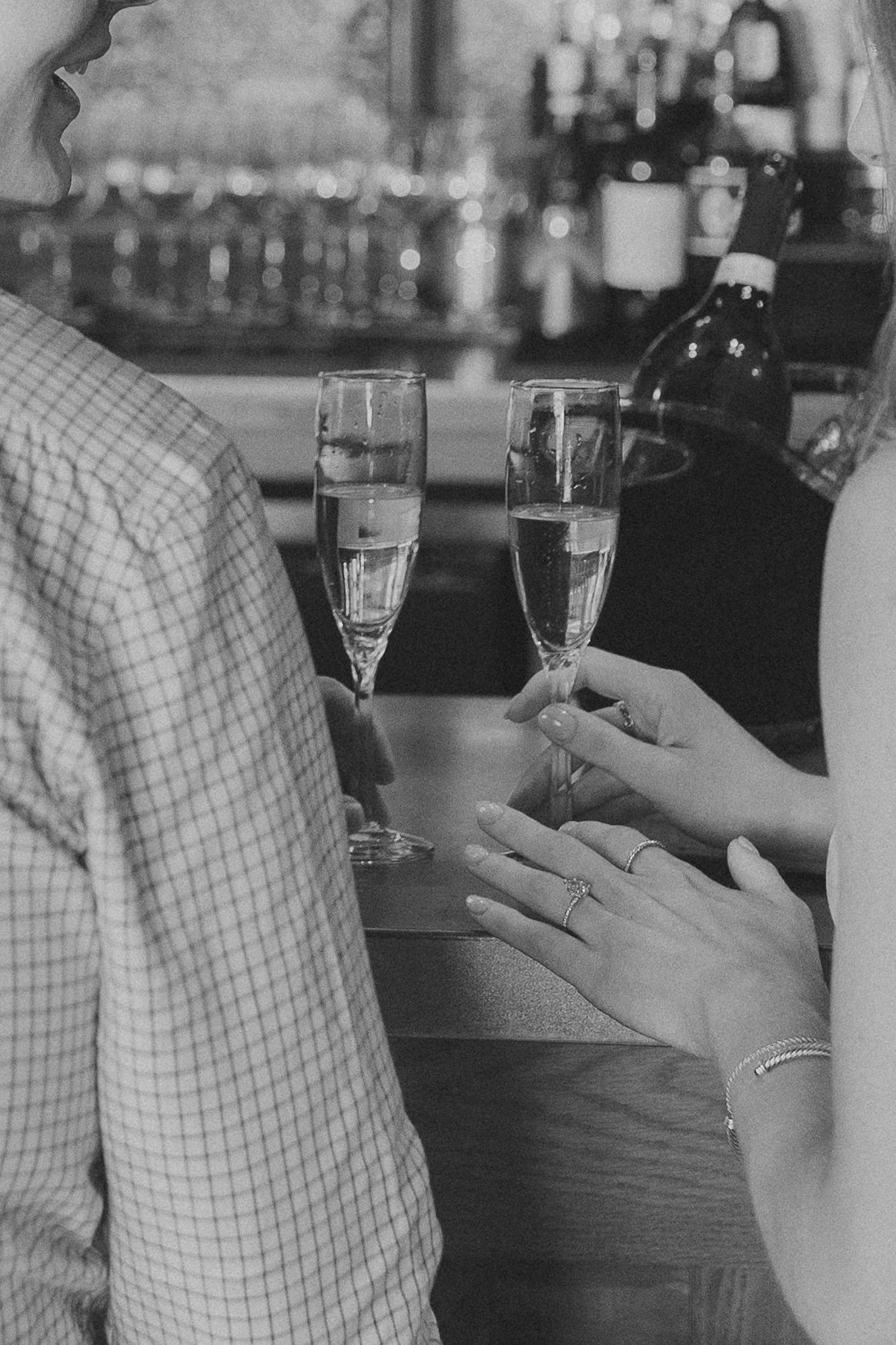Black and white image sequence showing champagne glasses and hands during a celebration toast.