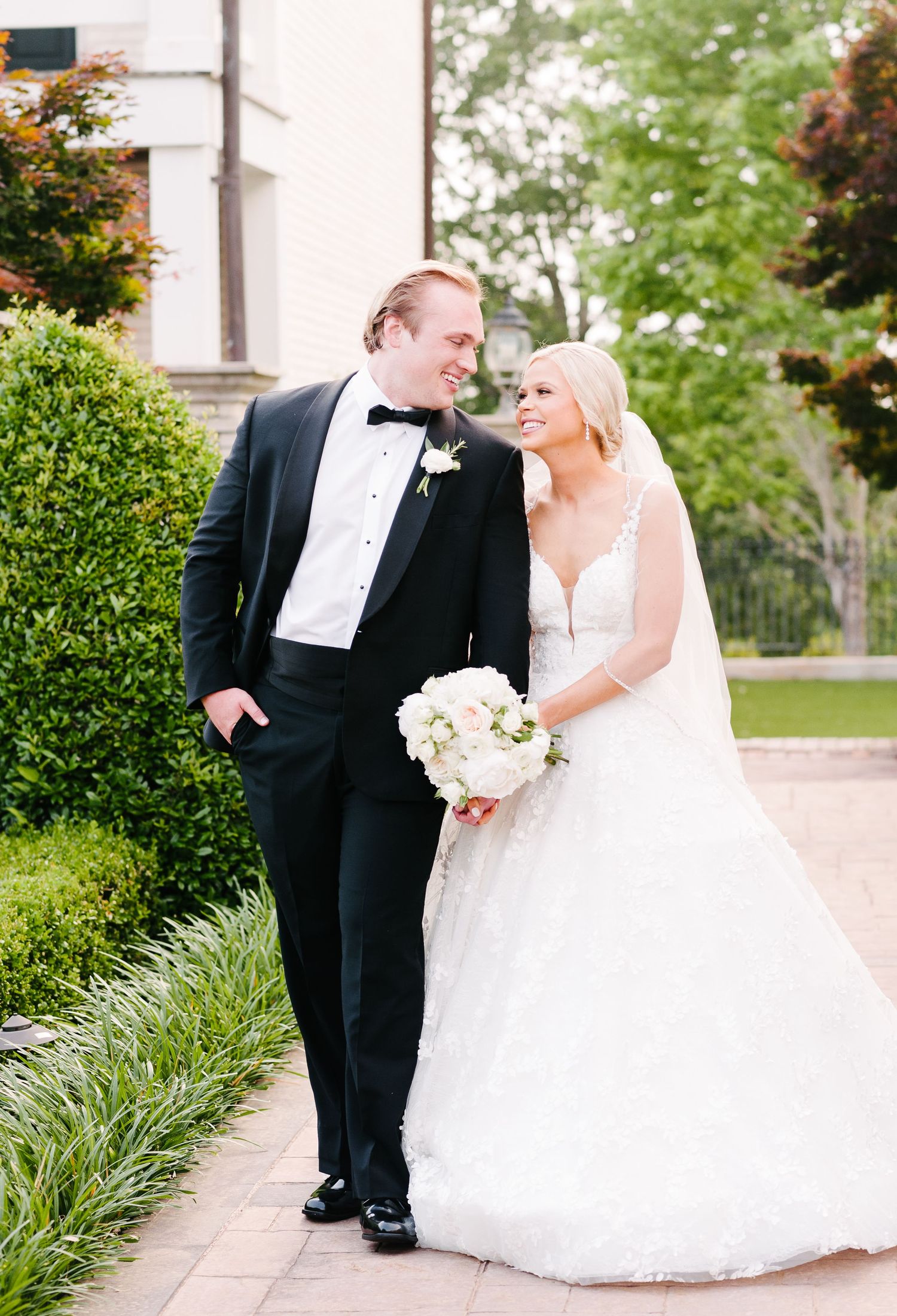 A sequence of romantic wedding photos showing a couple in formal attire sharing intimate moments in an outdoor garden setting at Castle Hil.