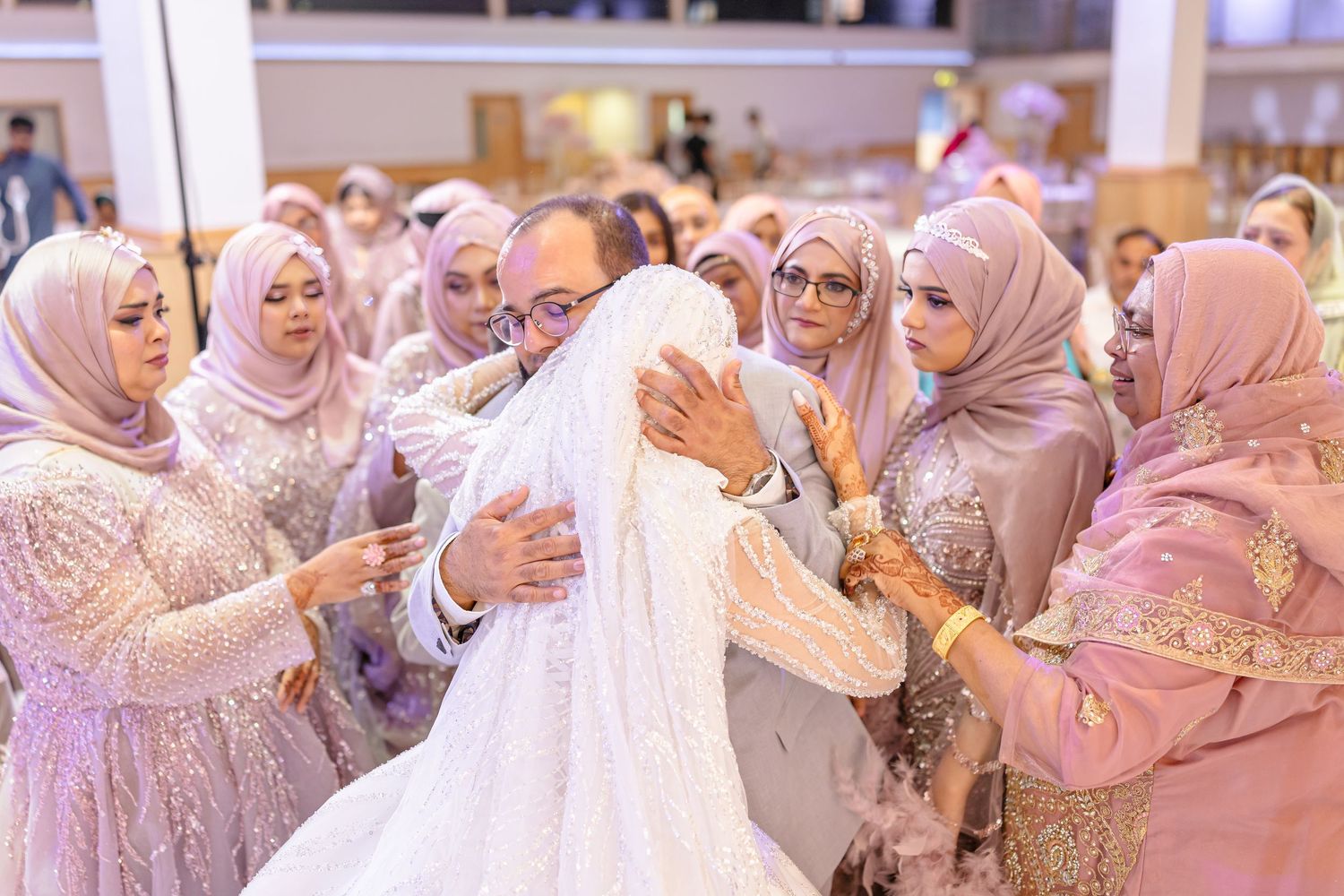 An emotional moment between a father and daughter as a bride wishing her a final farewell along with other ladies in the family