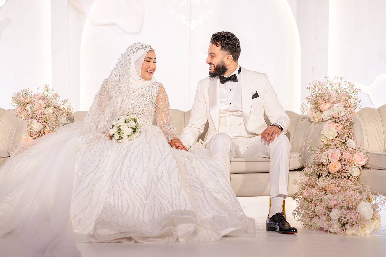 A collection of elegant wedding photographs showing couples in white gowns and formal wear against romantic floral backdrops.