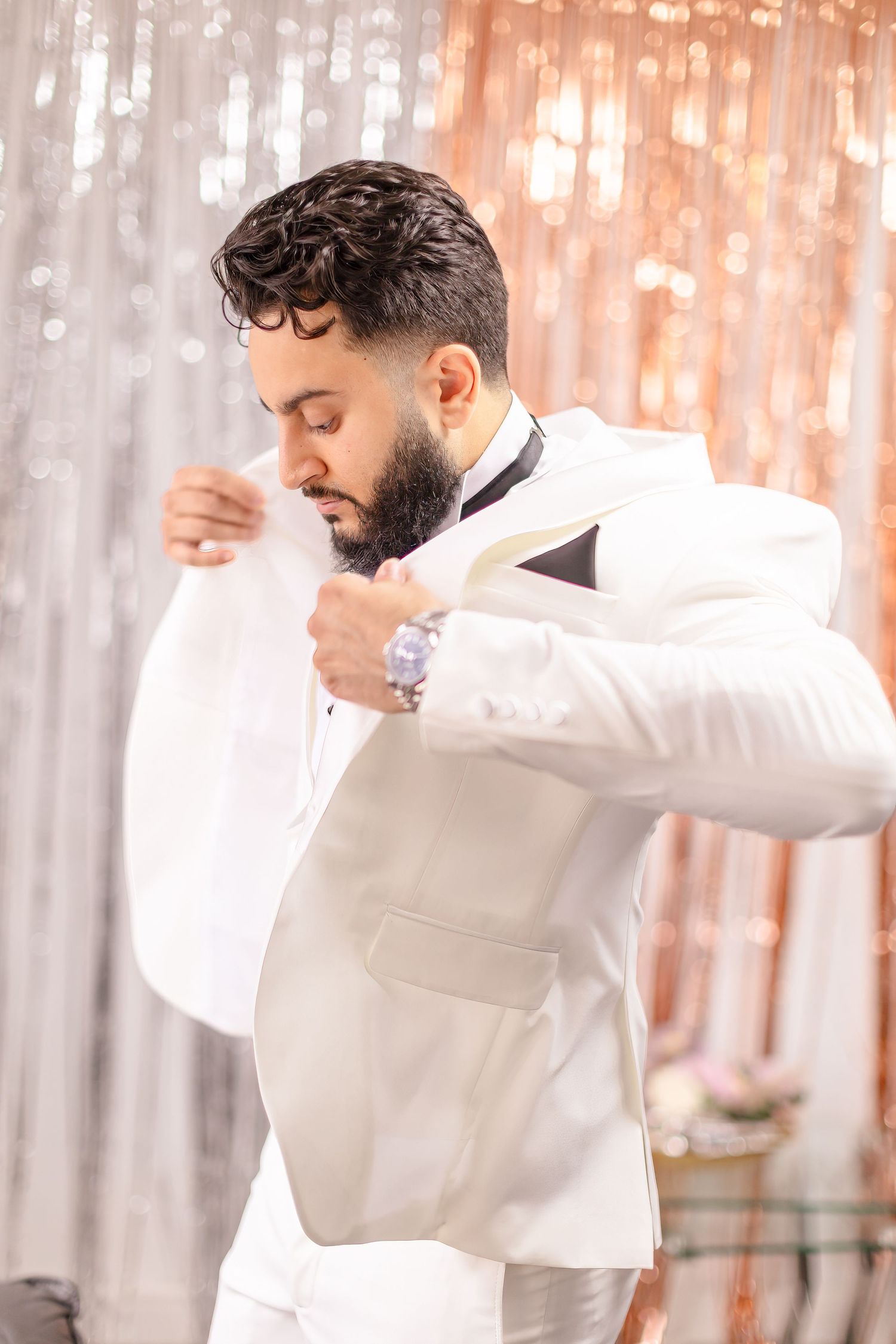 A person wearing white clothing spins and dances in front of an illuminated light background with a dreamy atmosphere.