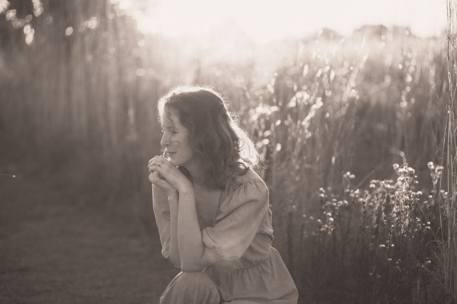 A series of romantic black and white photos showing a couple embracing in dreamy backlit sunlight.