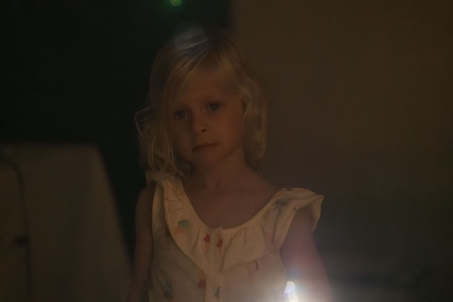 A series of dark, dimly lit portraits showing someone in shadow with dramatic lighting effects.