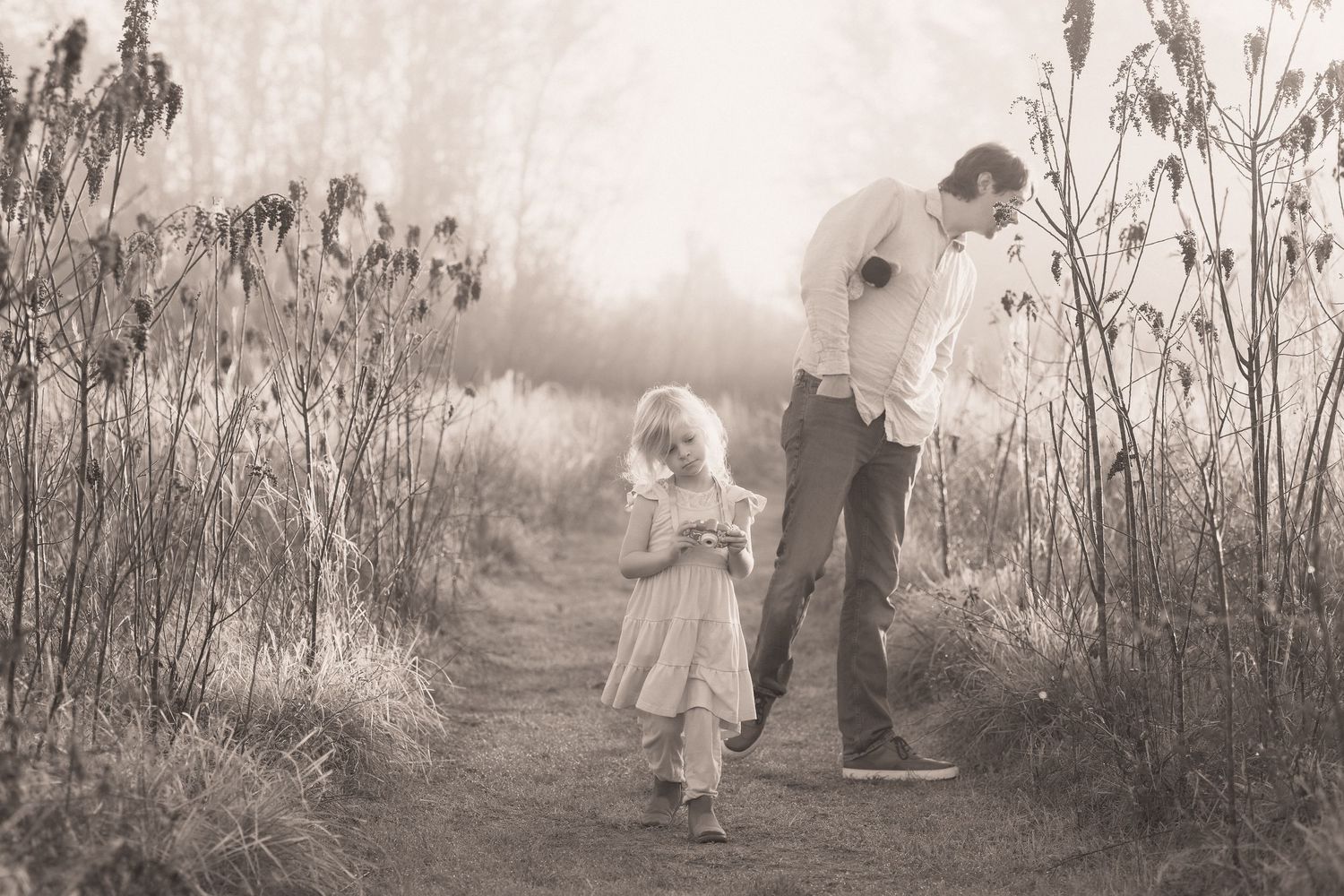 Black and white photo series showing figures walking through a misty wooded path in an ethereal setting.