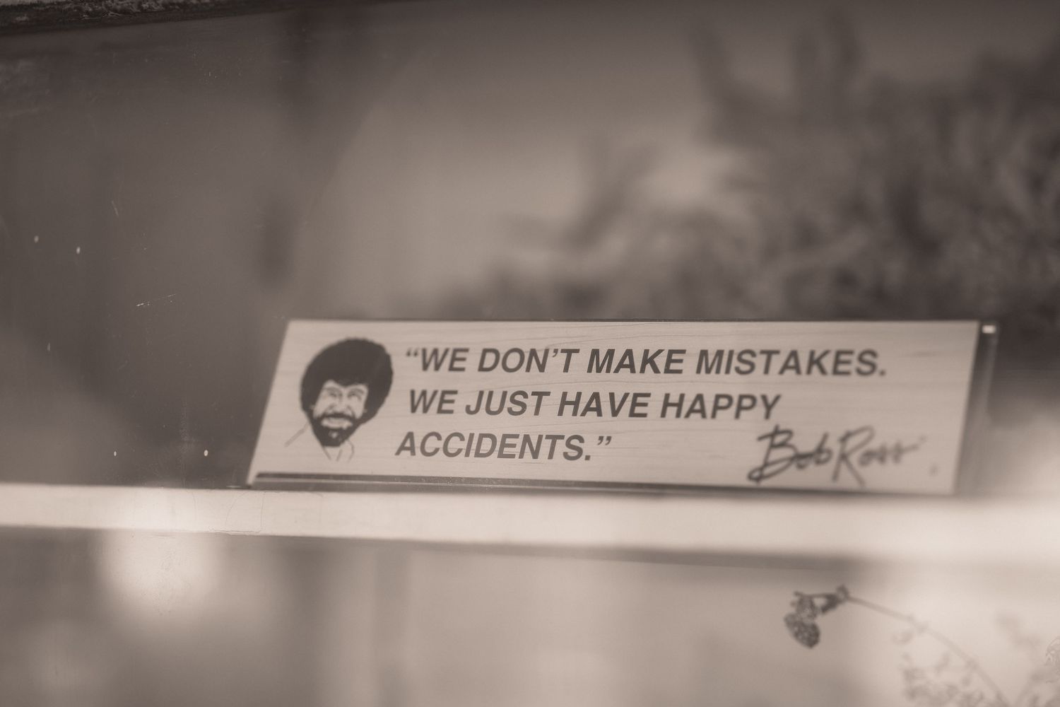 Bob Ross quote sticker reading We Don't Make Mistakes We Just Have Happy Accidents in sepia tone.
